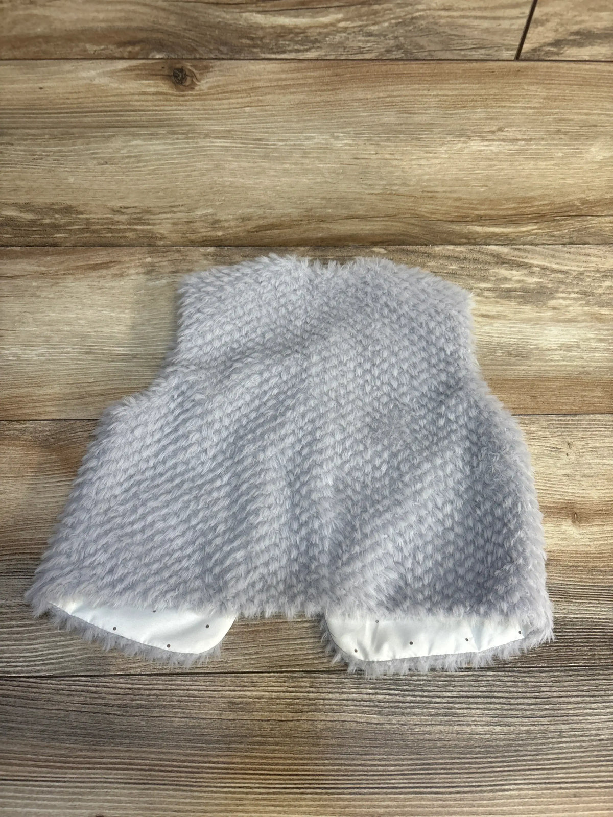 Back view of gray Mayoral faux fur vest size 12 months showing soft fuzzy texture and white satin lining on wood background