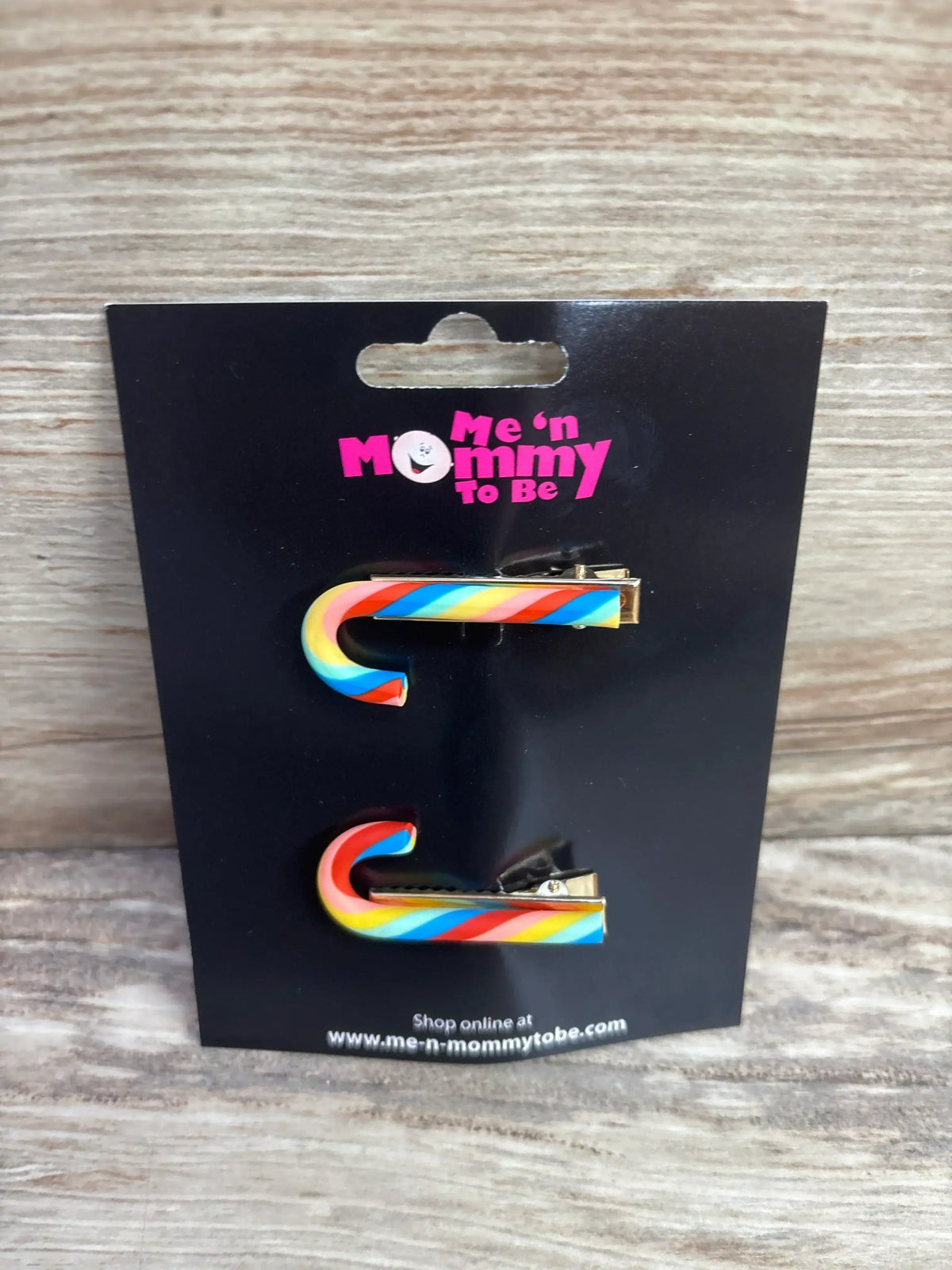 Rainbow candy cane hair clips for kids, colorful holiday accessories on black card
