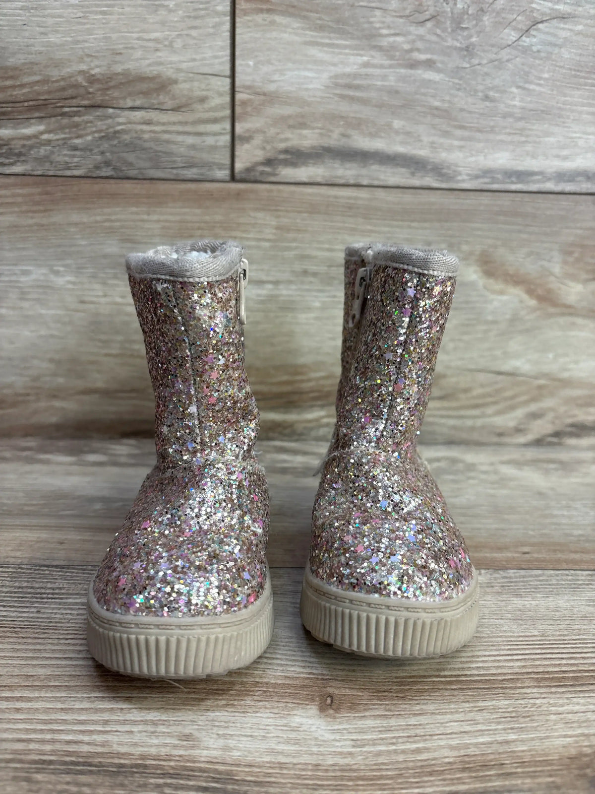 Front of Cat & Jack Holland shearling-style toddler boots 5C, gold glitter, side zippers and faux shearling on wood floor