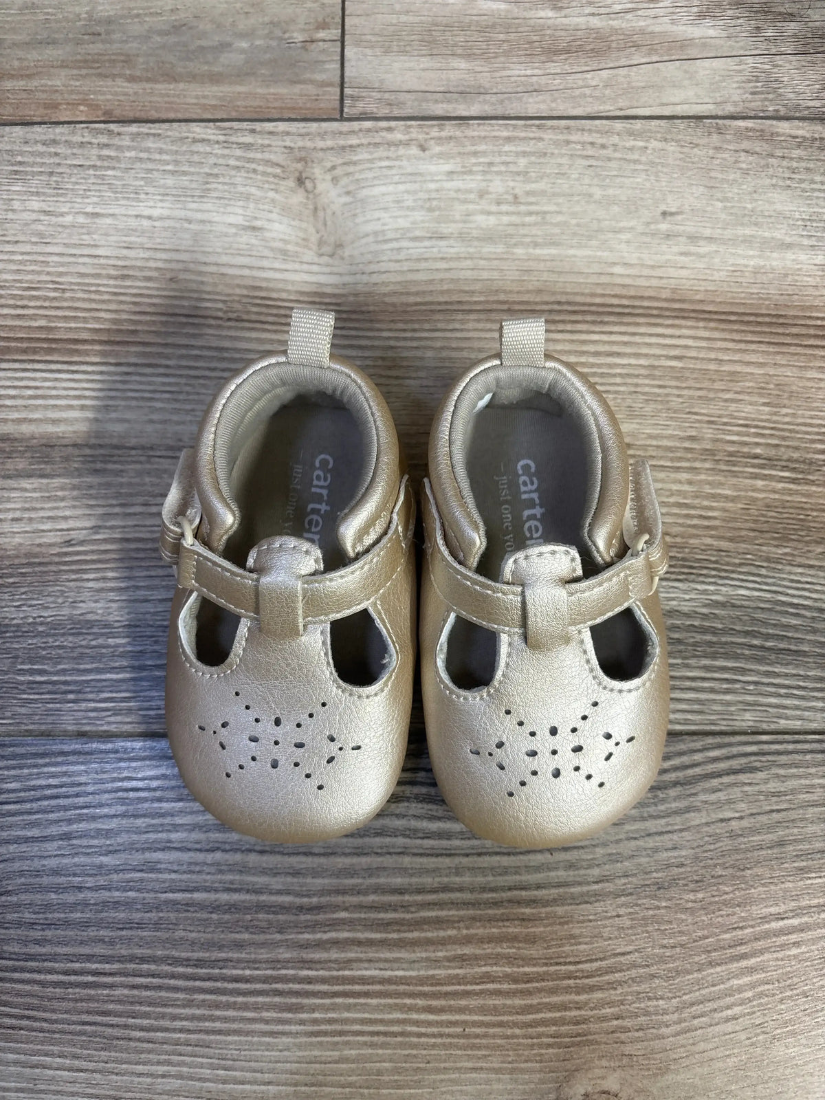 Top view of gold Just One You Stella pre-walker closed-toe sandals, size 2/3C, with perforated toes and hook-and-loop straps