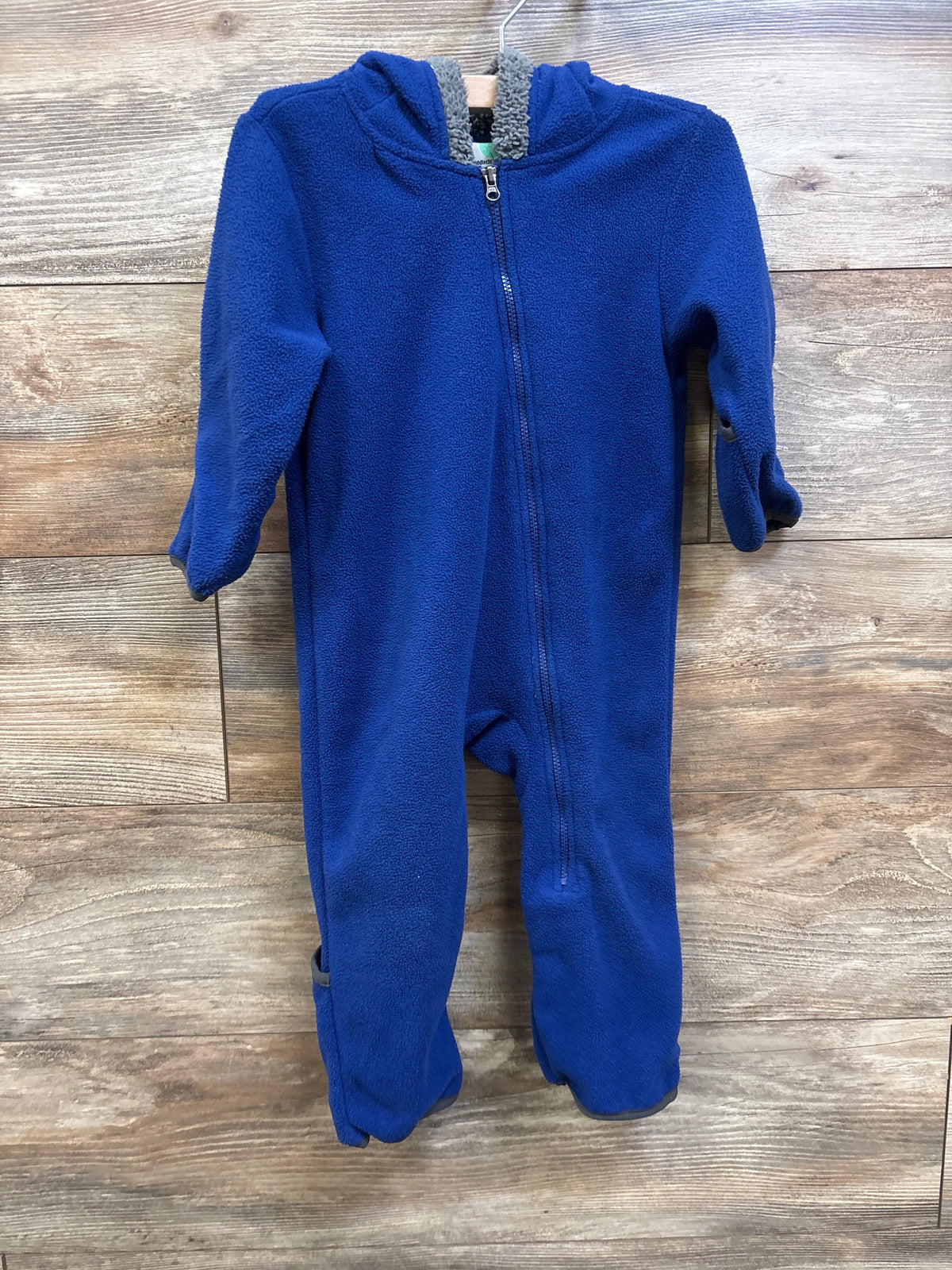 Cuddle Club blue fleece hooded bear bunting for babies, size 12-18m, on a wooden background