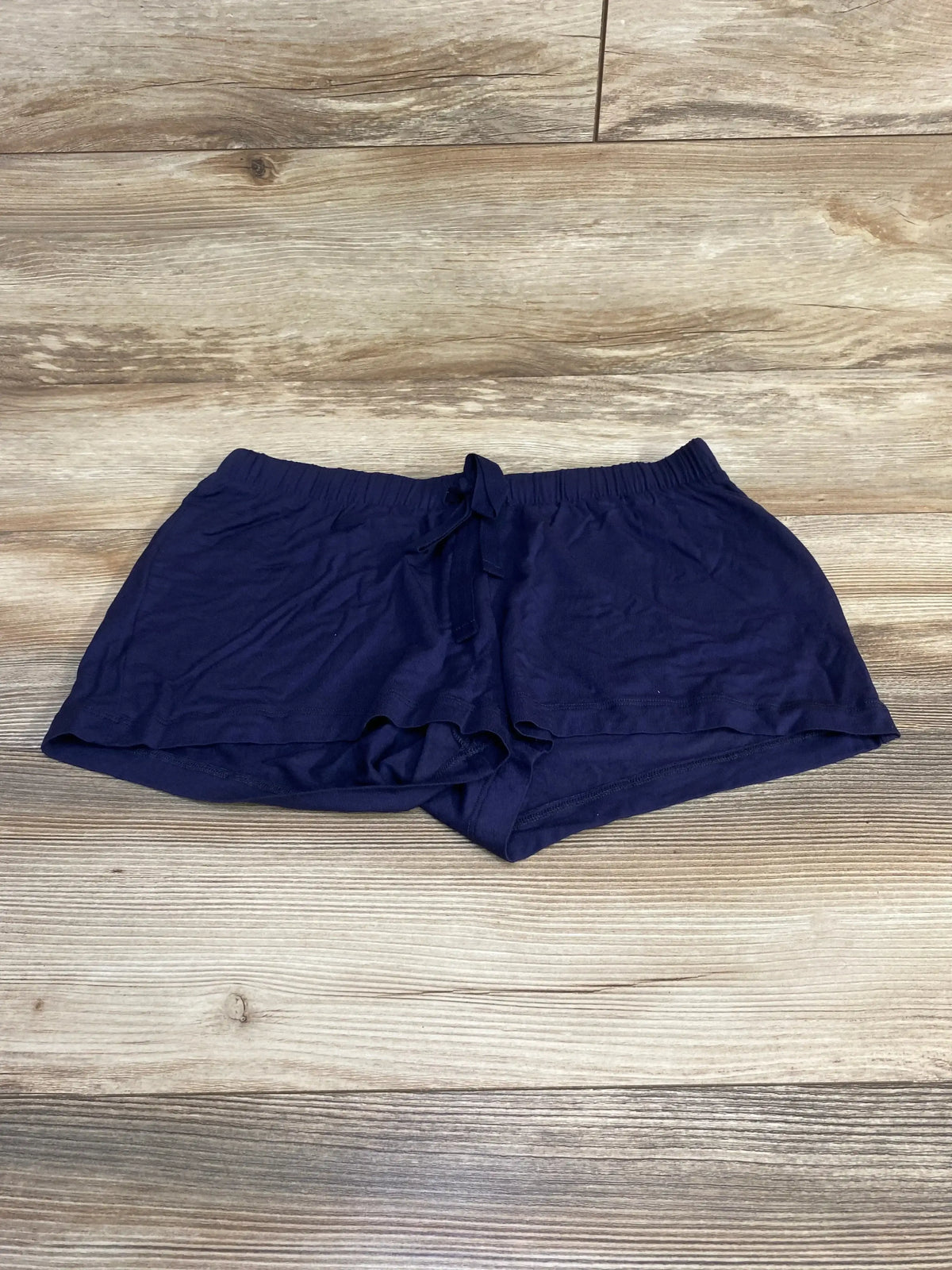 Front view of Gap Body maternity modal shorts in navy size XS, high-rise elastic waistband and mid-thigh length on white background
