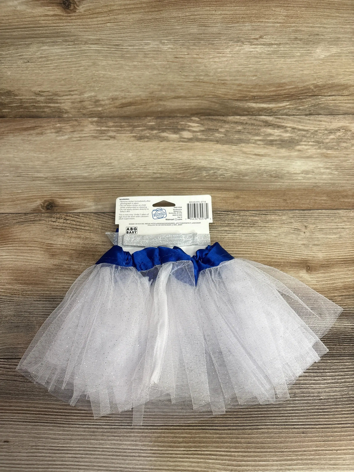 White tulle baby tutu with blue waistband, perfect for infant photo props or dress-up