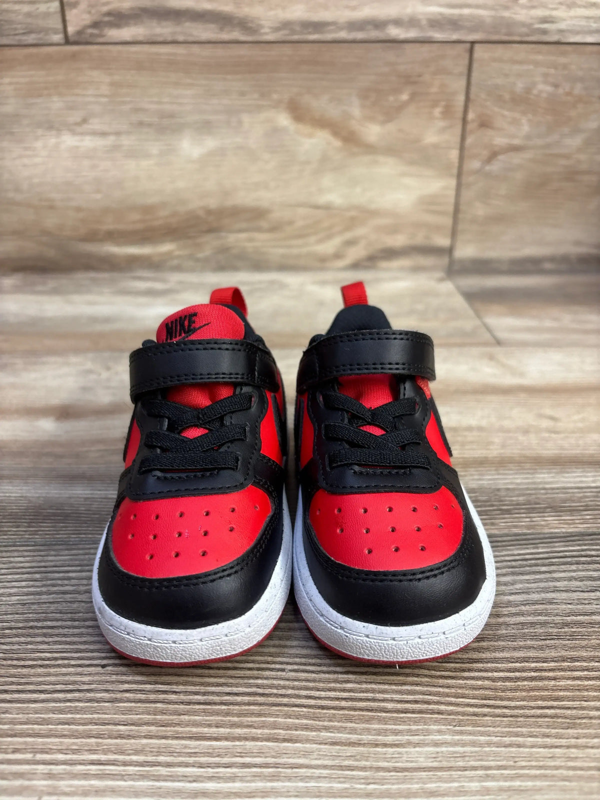 Front view of Nike Court Borough Recraft TD sneakers showcasing red and black uppers, laces, and hook-and-loop straps