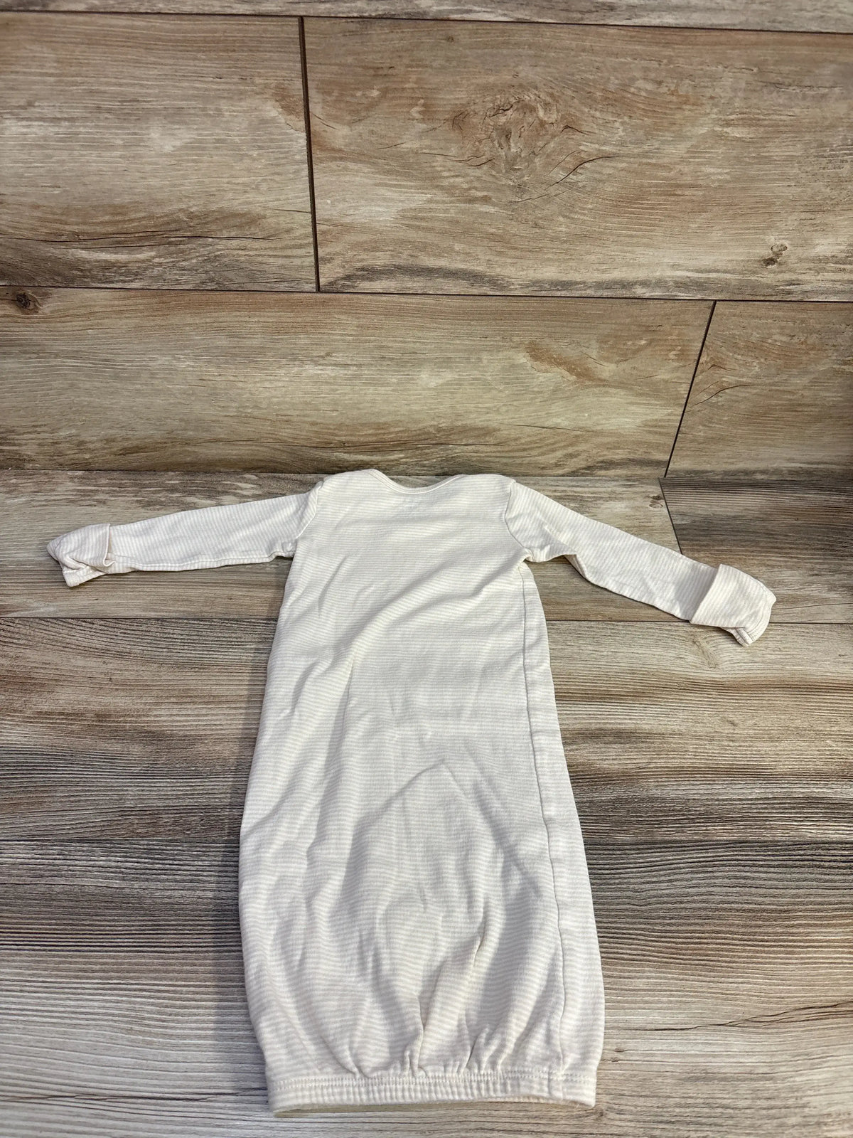 Front view of Carter’s beige striped sleep gown showcasing long sleeves and elasticized bottom on a wood-look floor
