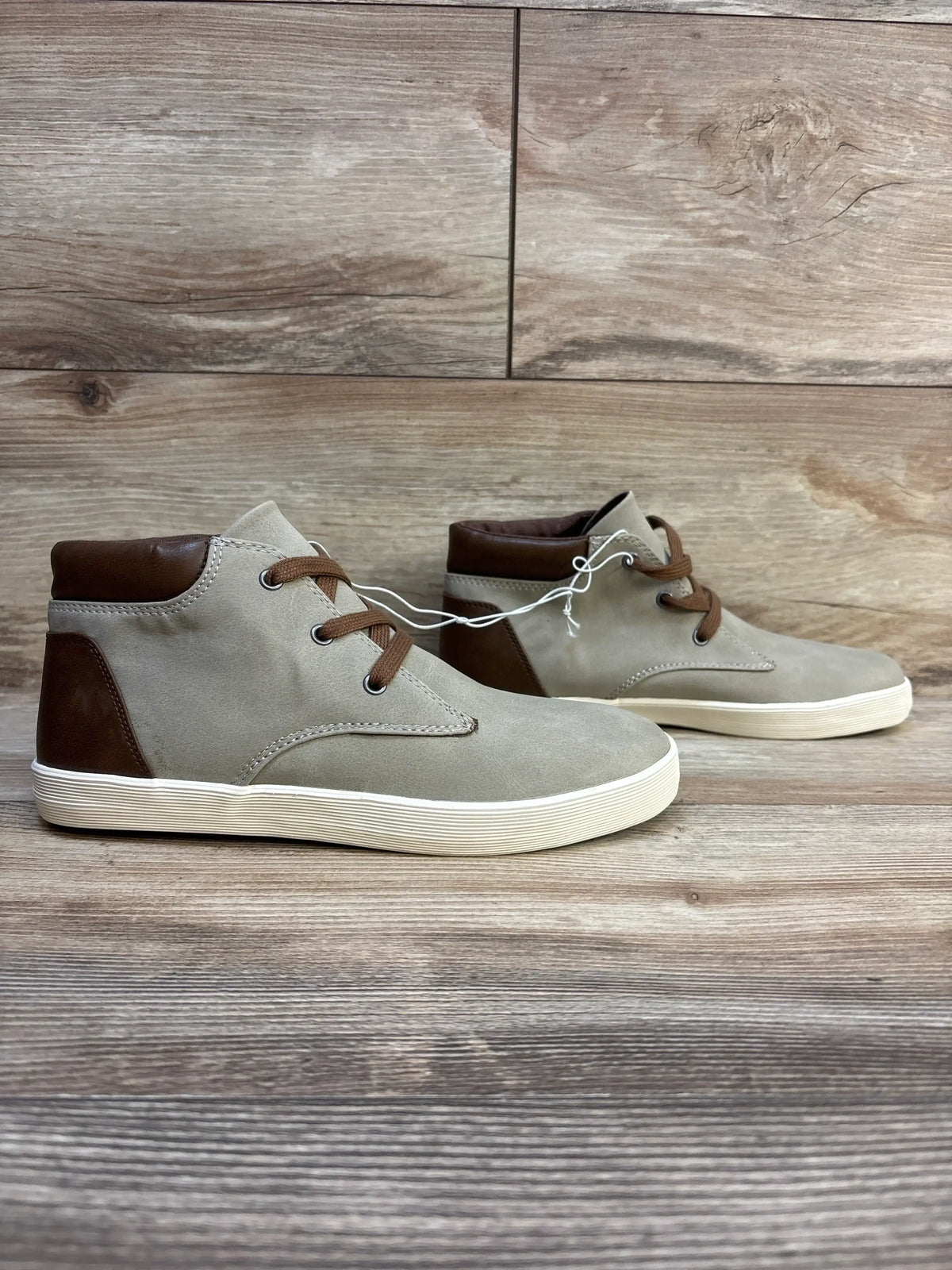Side view of Cat & Jack Jakob kids high-top boots in grey with brown accents and white rubber soles on wooden floor