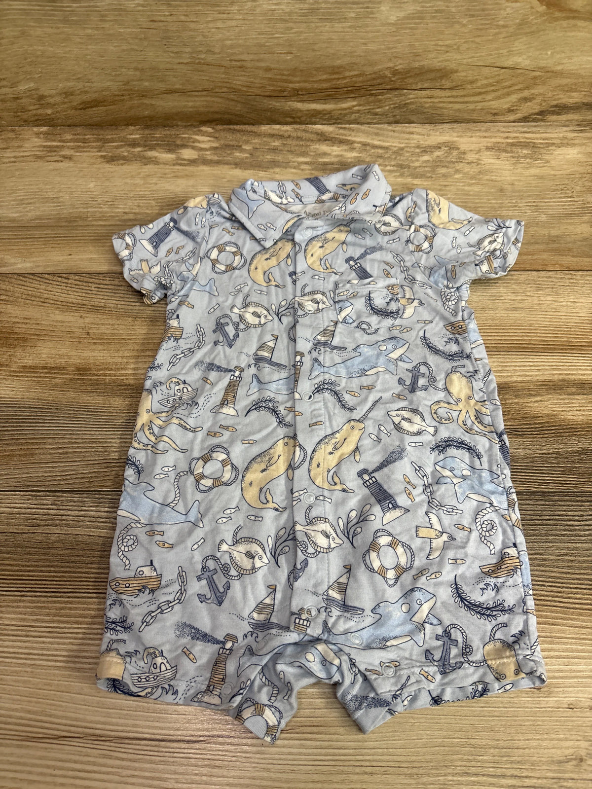 Blue Angel Dear bamboo button-front shortie romper with nautical print on wooden background
