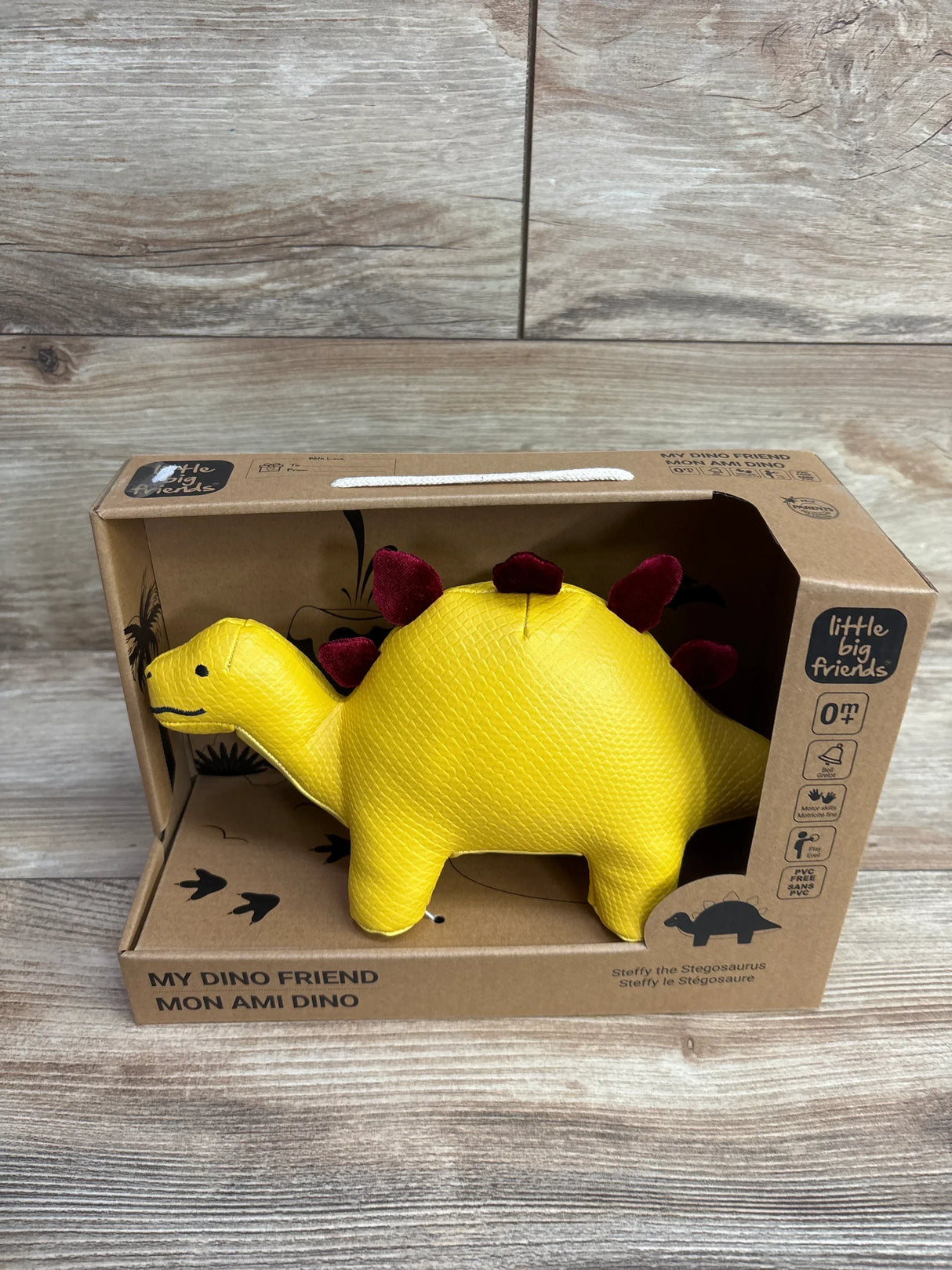 Yellow Stegosaurus plush toy with red spikes in eco-friendly packaging from Little Big Friends
