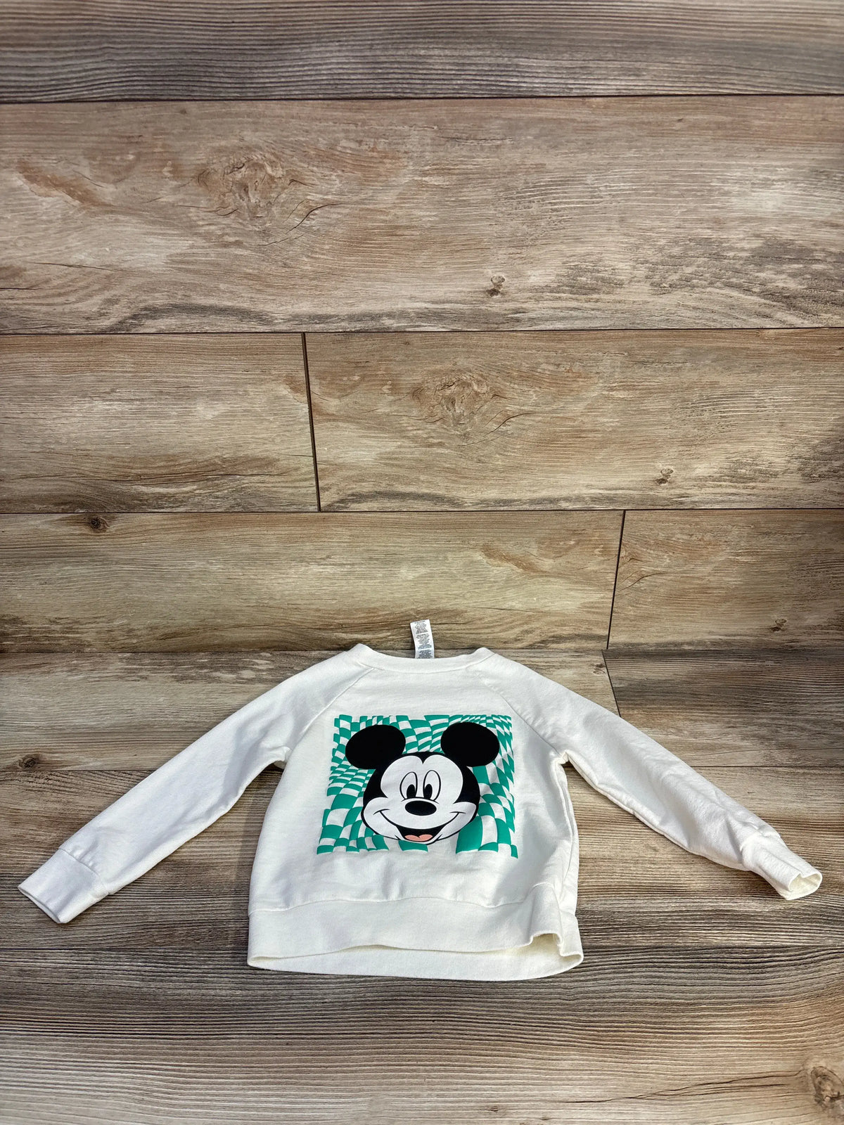 Front view of Disney Mickey Mouse long sleeve shirt showcasing a Mickey Mouse graphic with a wood plank background