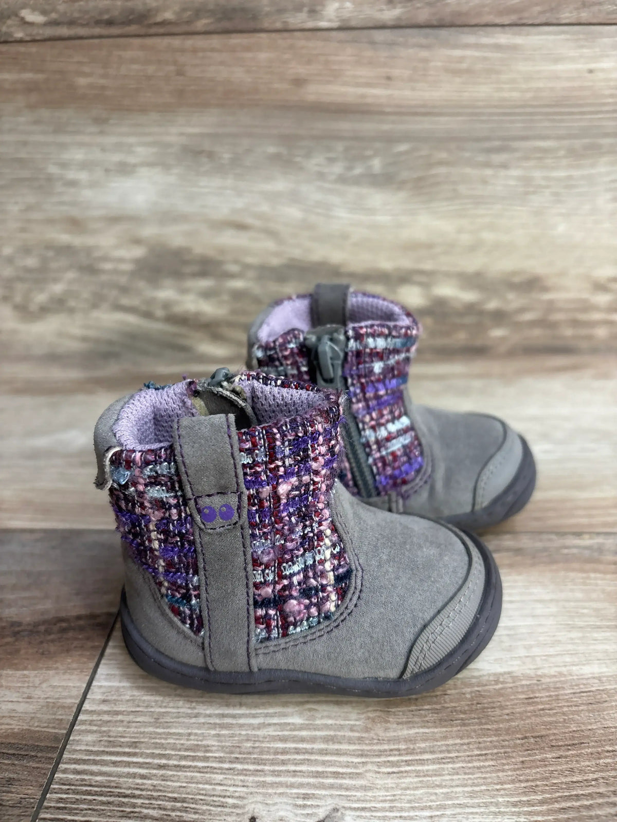 Gray toddler boots with purple plaid knit sides and zipper on wood background