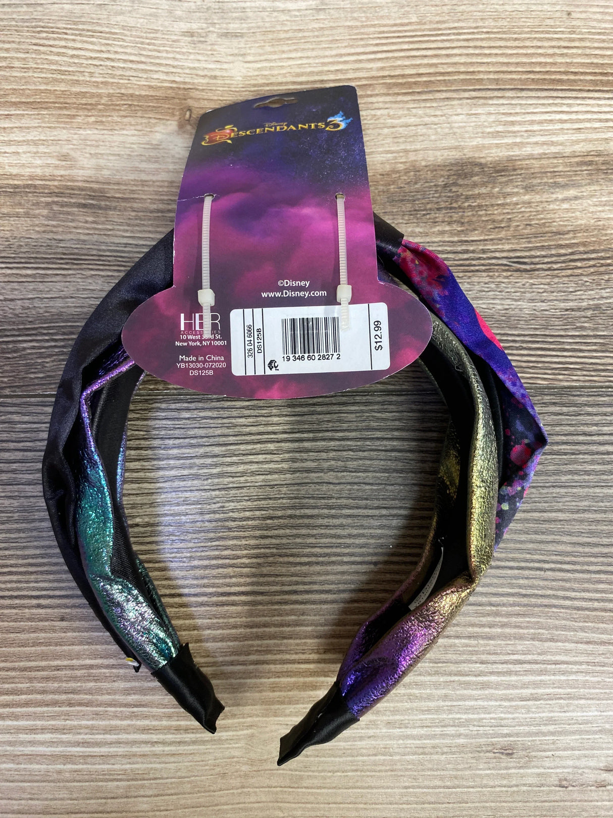 Disney Descendants 3 multicolor metallic headband on wood surface with retail tag