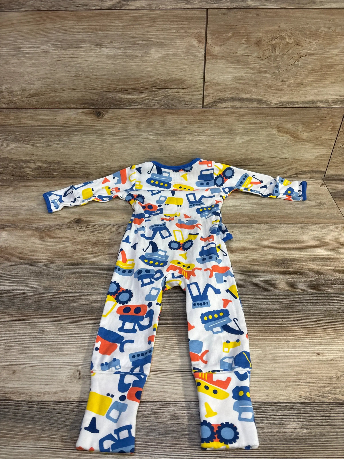 Flat lay of OETEO convertible sleeper romper, white with multicolor vehicle print, long sleeves and convertible foot cuffs