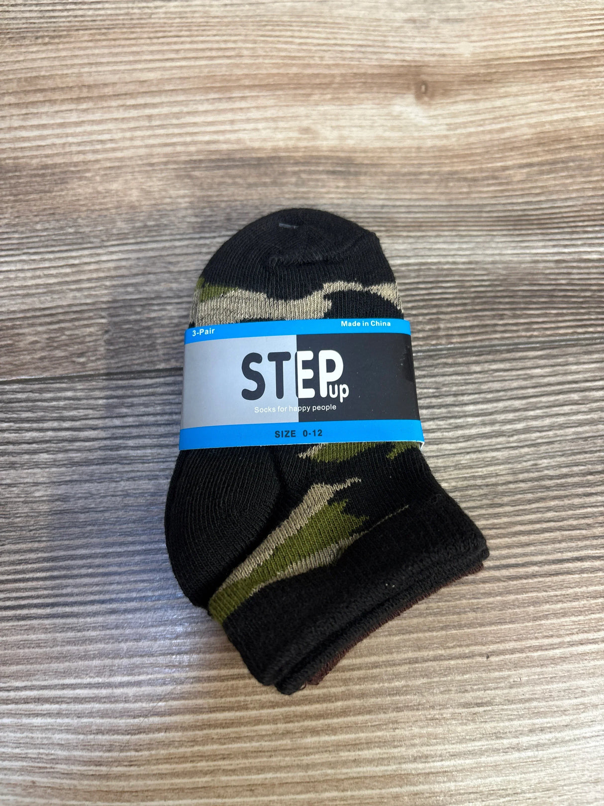 Camo print baby socks size 0-12 months, 3-pack, on wood background, kids clothing accessory