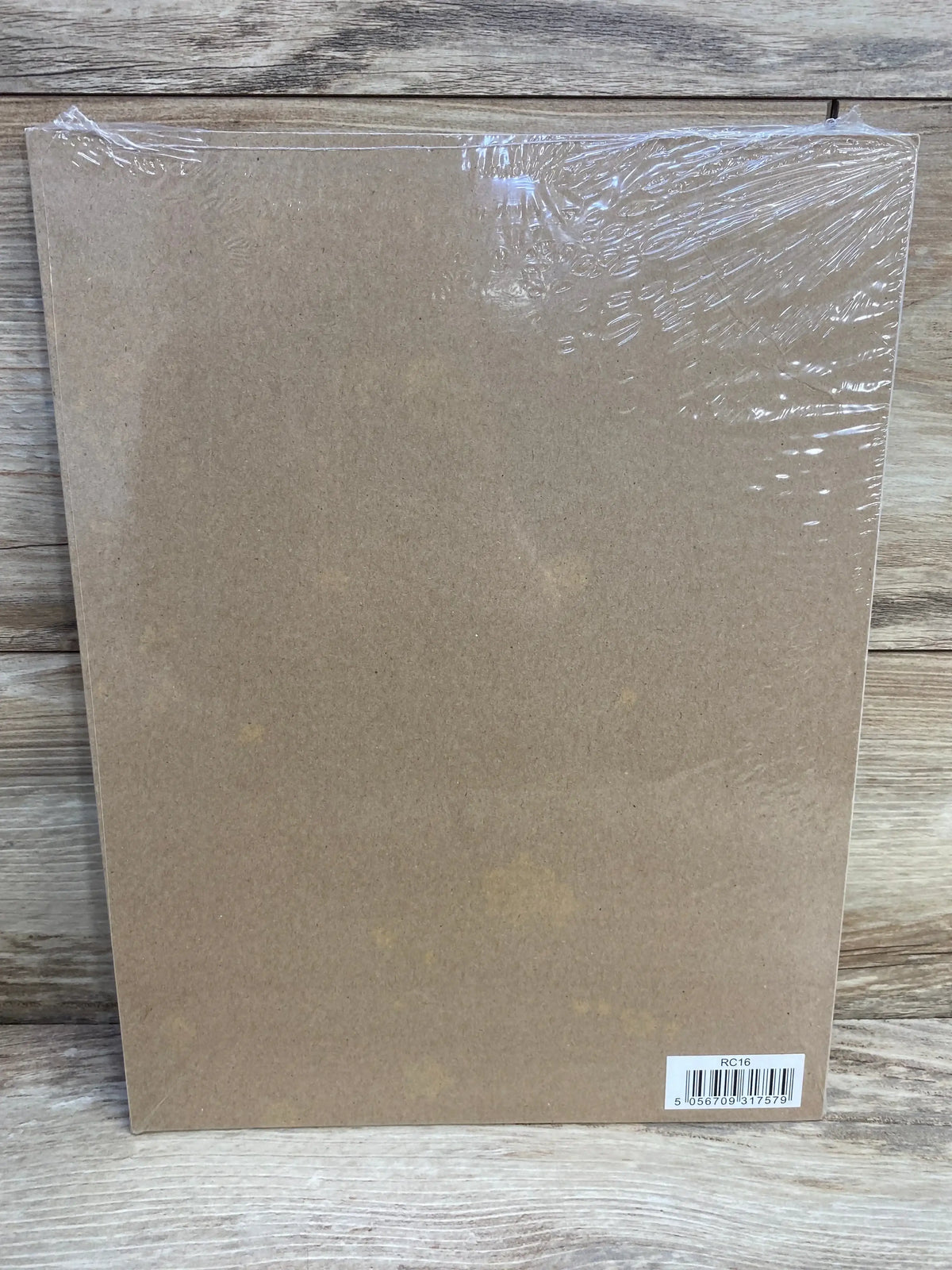 Rear view of NEW Central.23 reward chart, brown cardboard backing wrapped in clear plastic with barcode sticker lower right on wood background