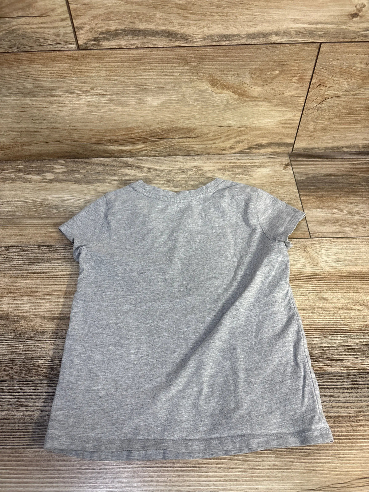 Back view of Cat & Jack toddler shirt showcasing plain grey fabric and short sleeves on a wood floor