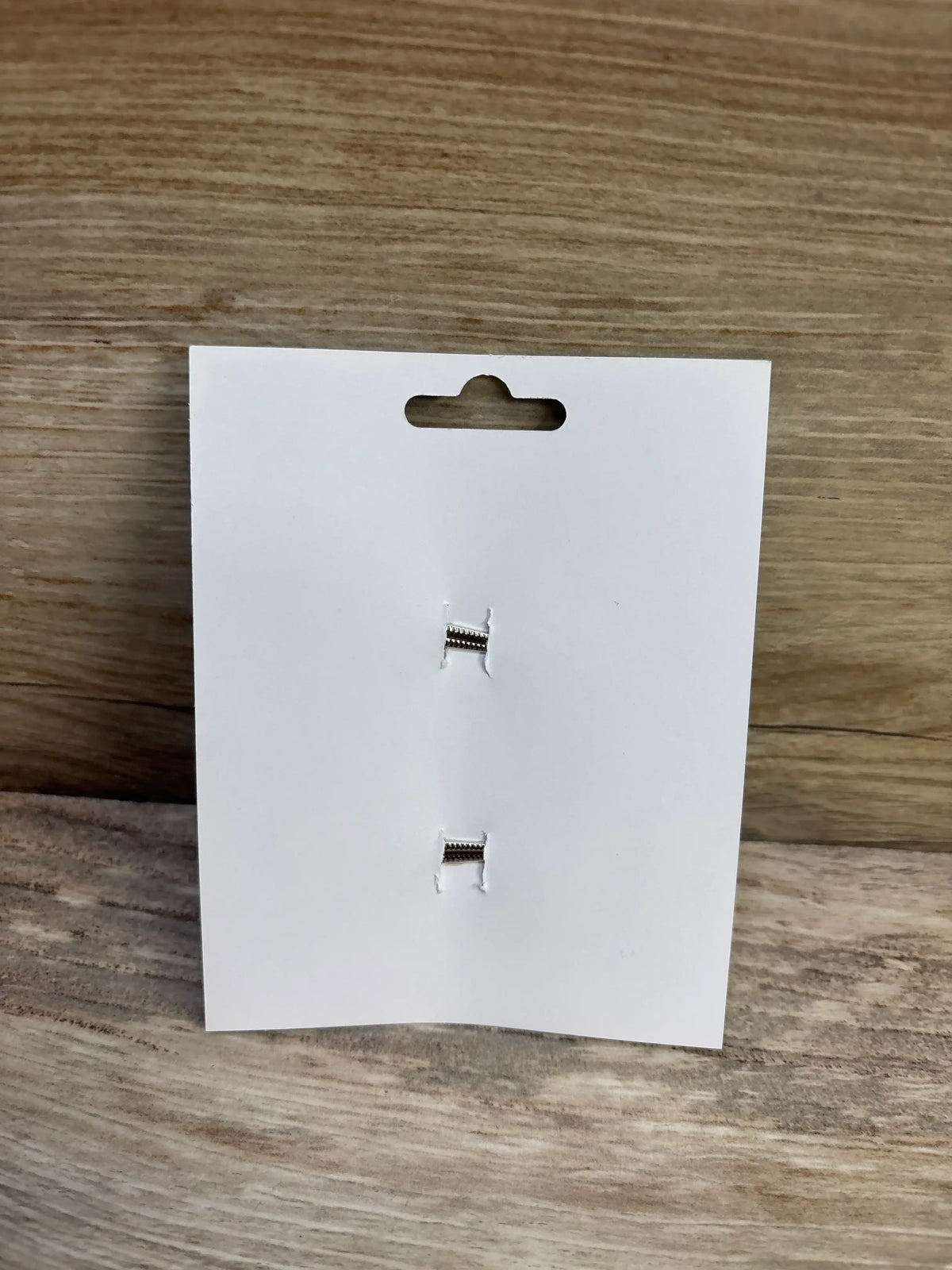 Back view of NEW Hair Bows 2pk Purple showcasing two silver alligator clips on a white display card and wood background