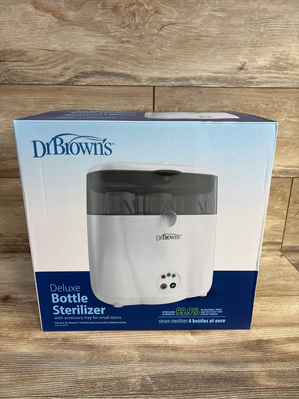 Dr. Brown's Deluxe Bottle Sterilizer in box on wood floor, steam sterilizer for 6 bottles