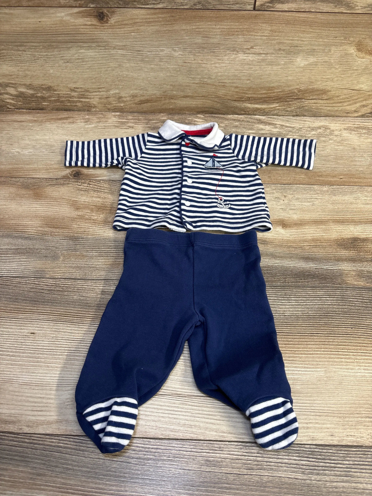 Little Me 2pc navy striped collared shirt and footed pants set for newborns on wooden floor