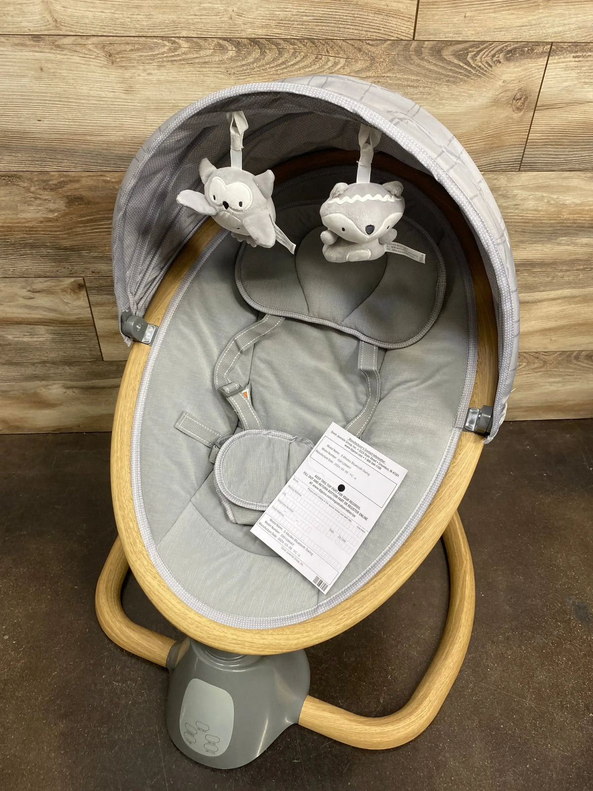 Top-down view of Safety 1st 5-Modes Bluetooth baby swing showcasing gray deep seat, canopy, plush toys, and five point harness