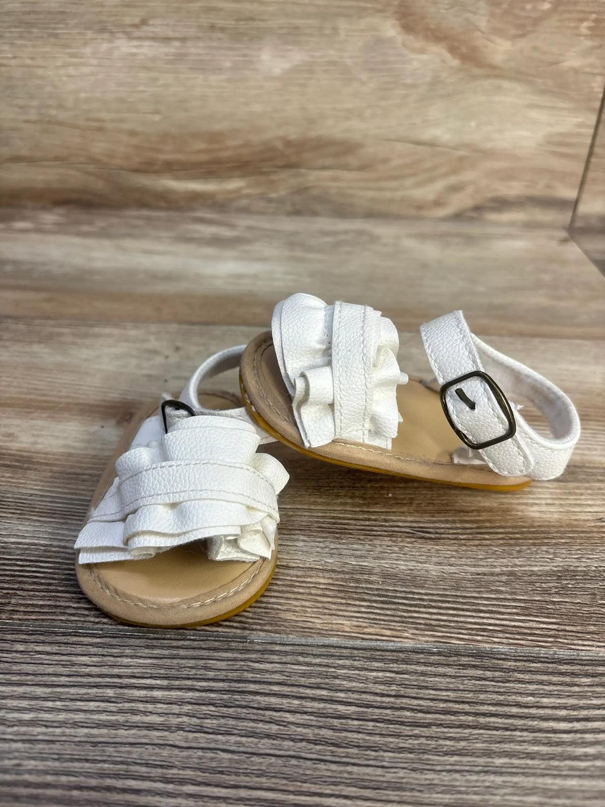 Front and side views of Muchenggift bowknot soft sole sandals showcasing white ruffled straps and adjustable ankle straps
