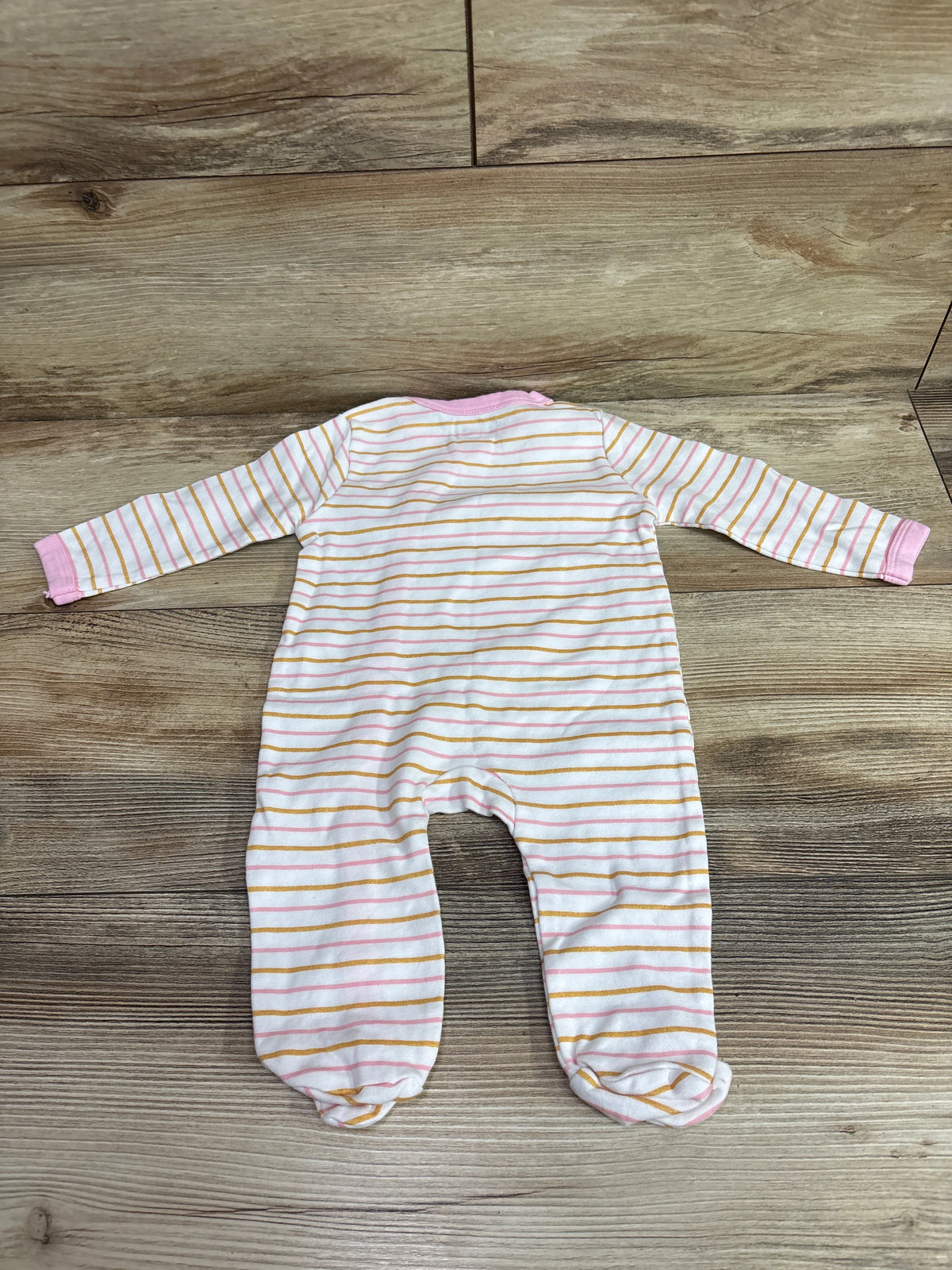 Front view of MAMIMAKA Rabbit Sleeper showcasing long sleeves, pink and gold stripes, and covered feet in size 6 months on a wood floor