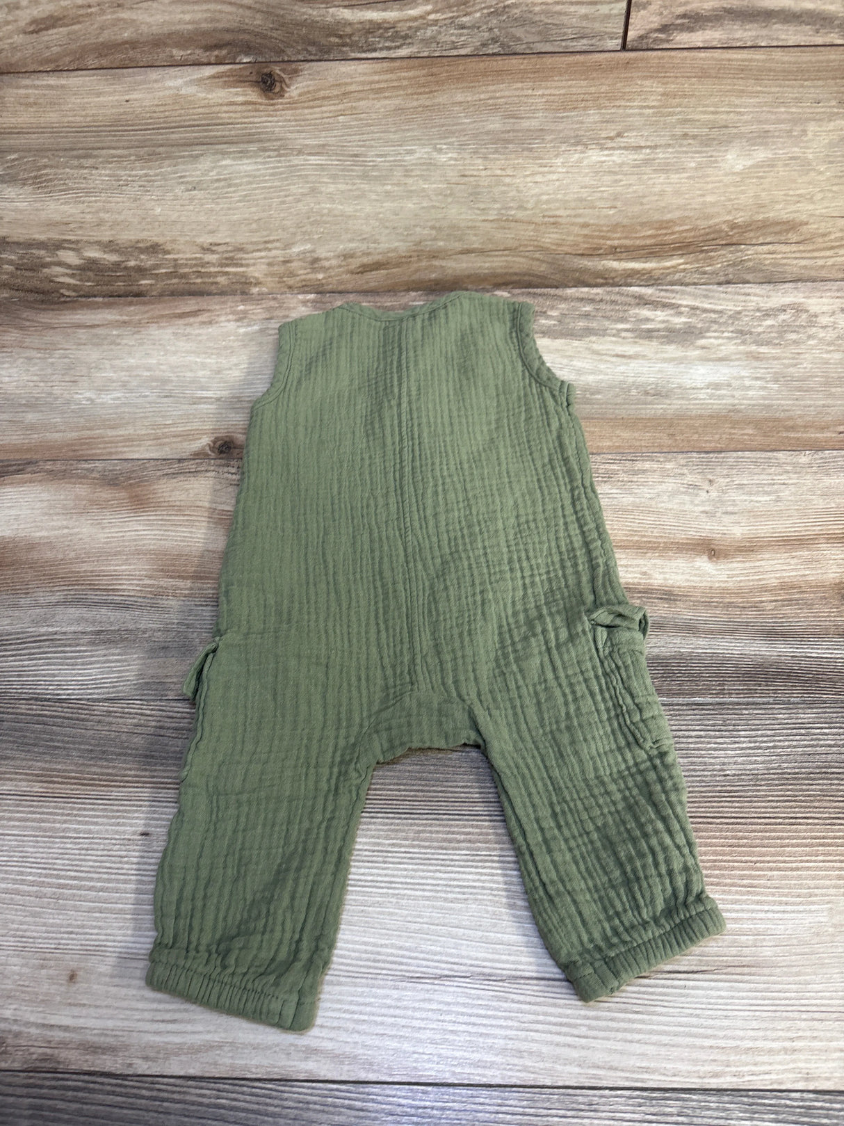 Front flat lay of Old Navy sleeveless henley pocket jumpsuit olive green 3-6m showing chest pocket and elastic ankle cuffs