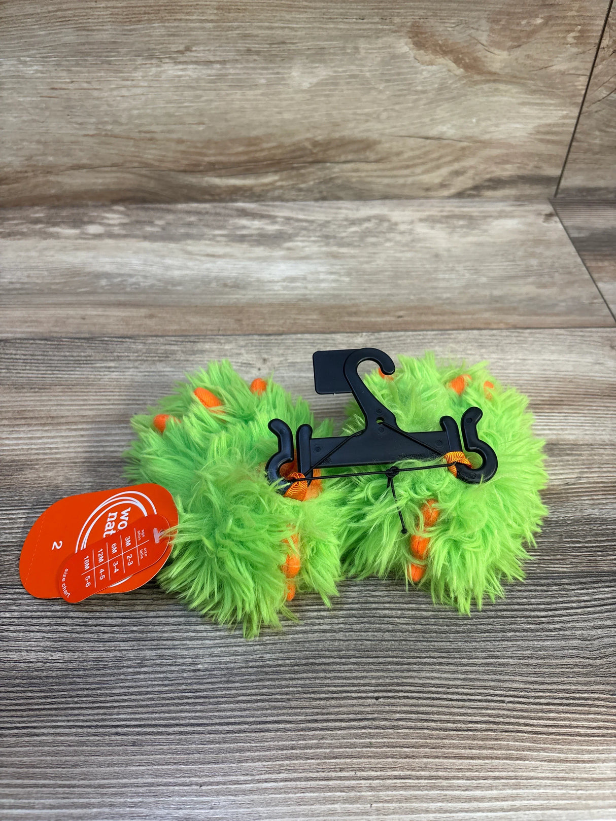 Neon green fuzzy baby toy with orange accents on hanger, size 2 tag, kids resale