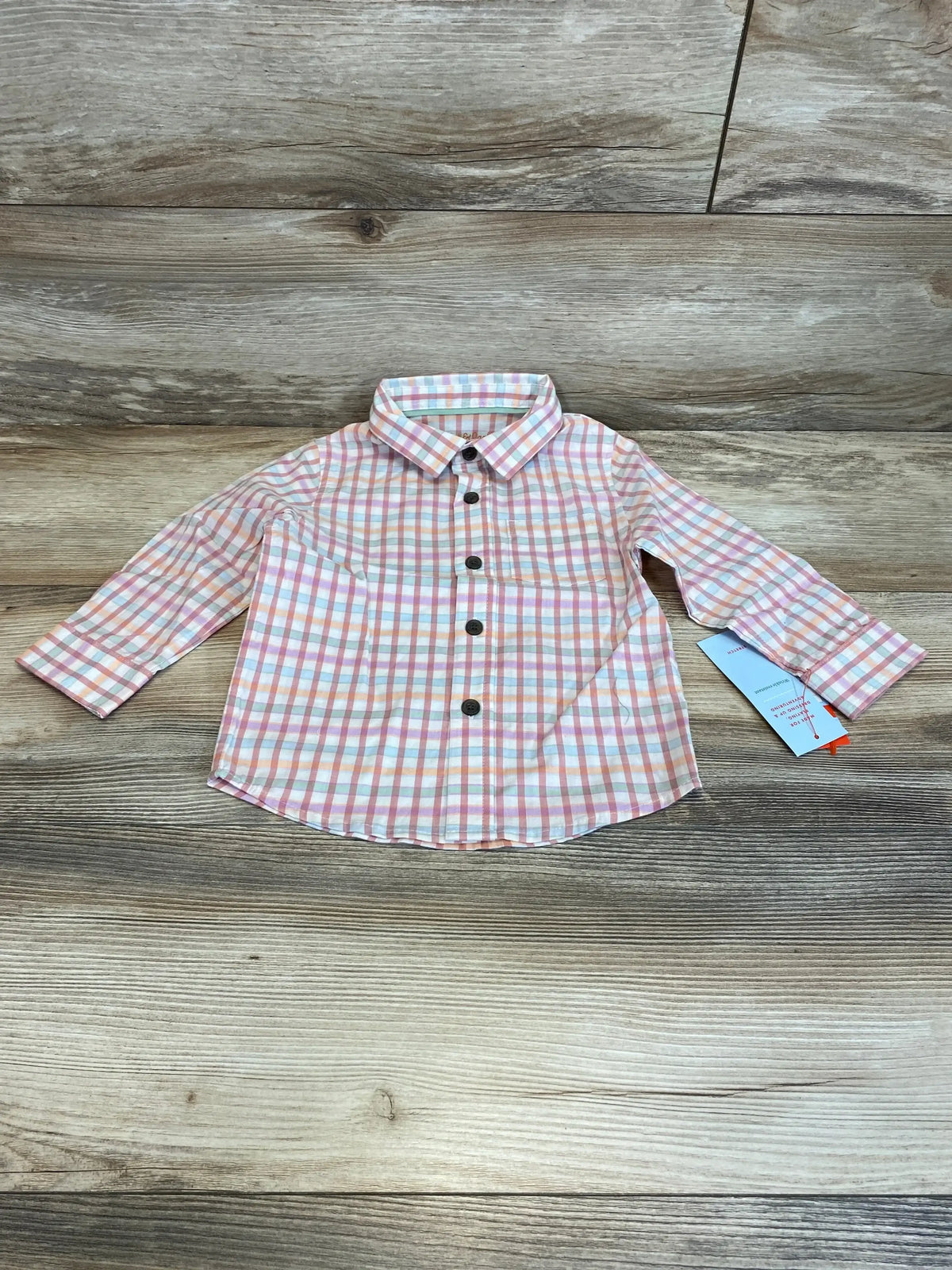 Front view of NEW Cat & Jack plaid button-up shirt showcasing pink plaid, collar, long sleeves, and black buttons on wood grain