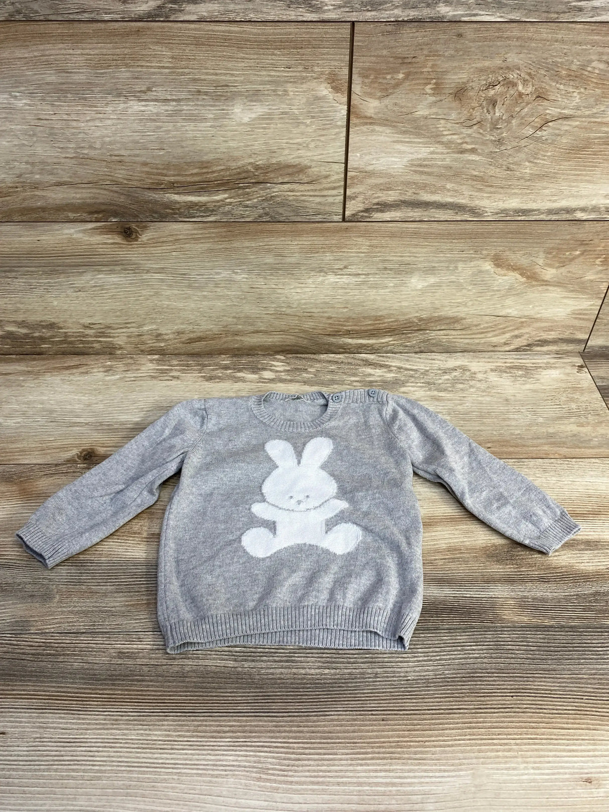 Front view of grey United Colors of Benetton baby sweater showcasing rabbit motif, size 9-12 months on white background
