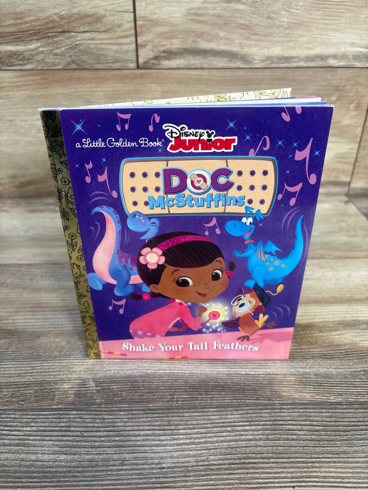 Disney Junior Doc McStuffins Little Golden Book Shake Your Tail Feathers on wood surface