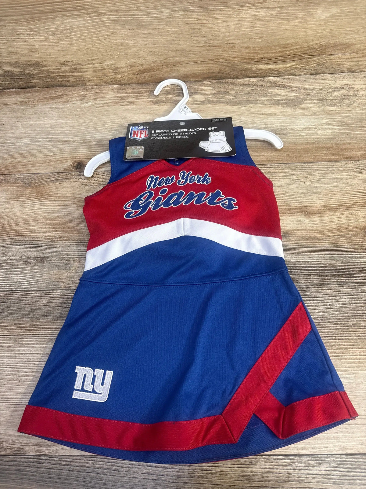NFL New York Giants toddler cheerleader dress in blue red and white on wooden surface