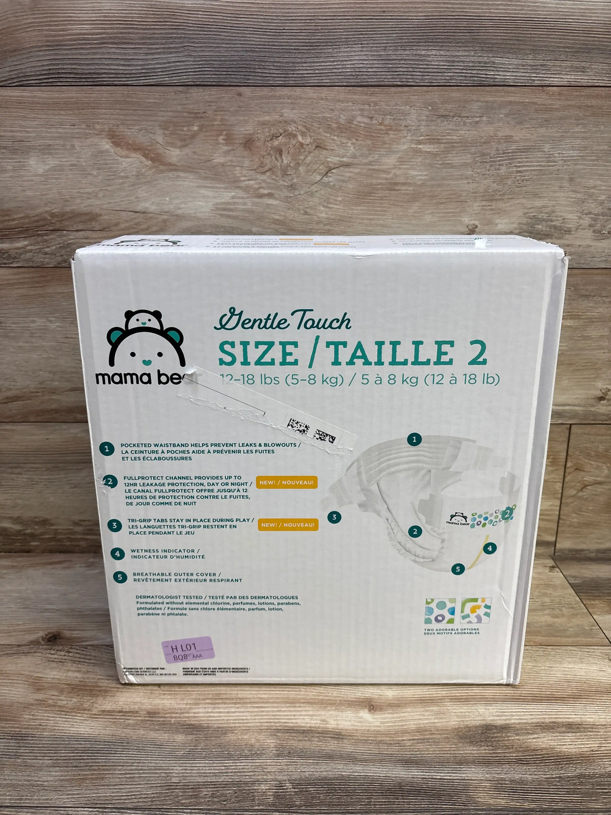 Front view of Mama Bear Gentle Touch diapers size 2 package showcasing leak protection features on a wood background