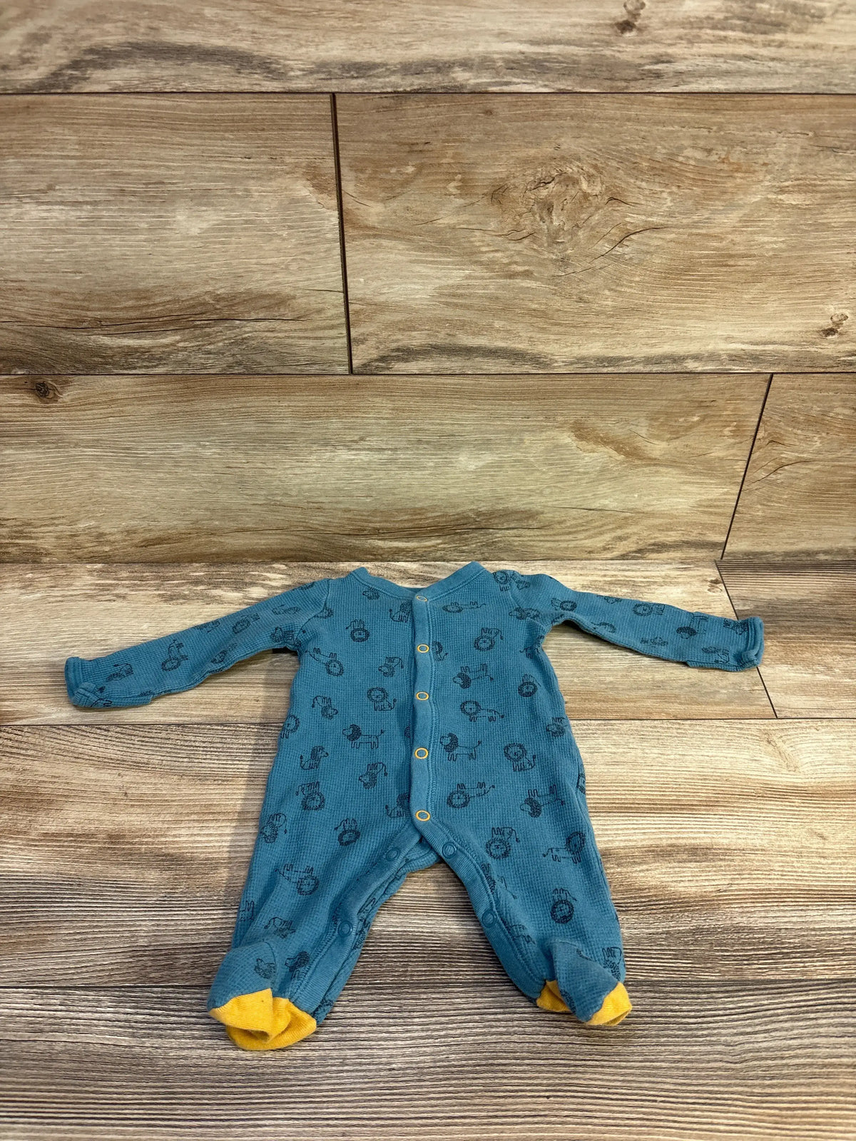 Carter's blue waffle knit newborn sleeper with a vehicle print and yellow feet