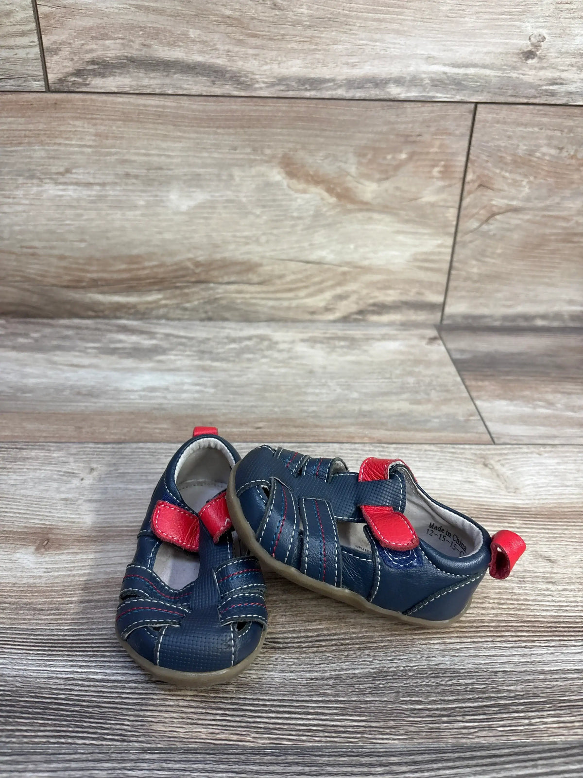 Side view of See Kai Run navy toddler fisherman sandal size 3C showing closed-toe woven straps and Velcro ankle strap