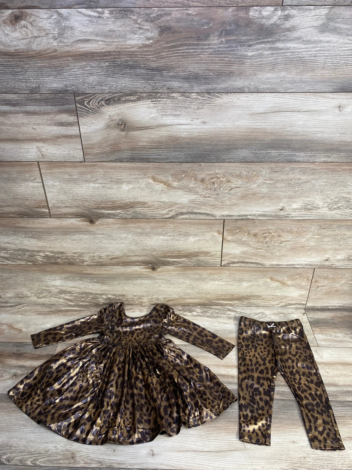 Leopard print long sleeve dress and matching leggings on wooden floor