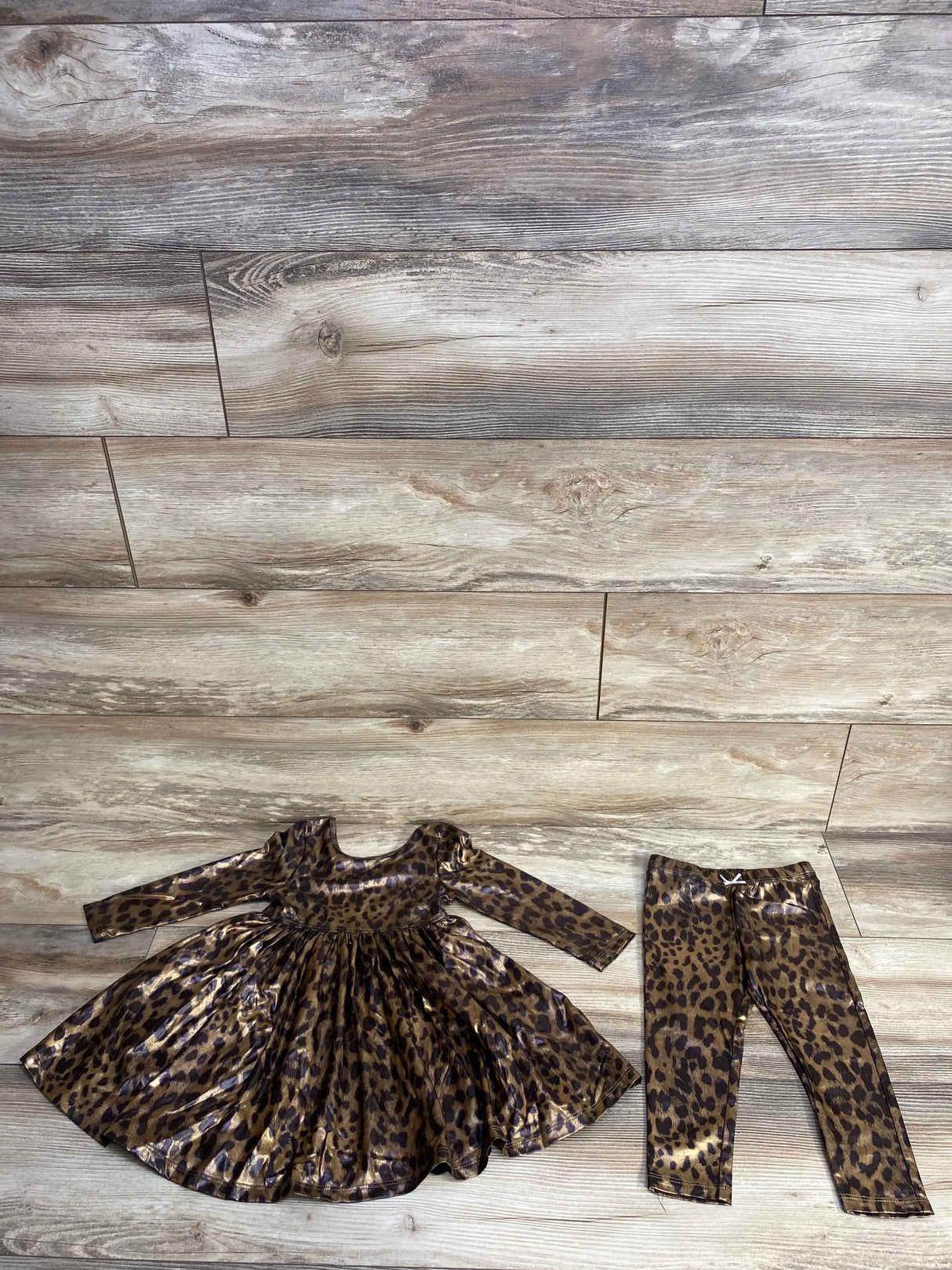 Leopard print long sleeve dress and matching leggings on wooden floor