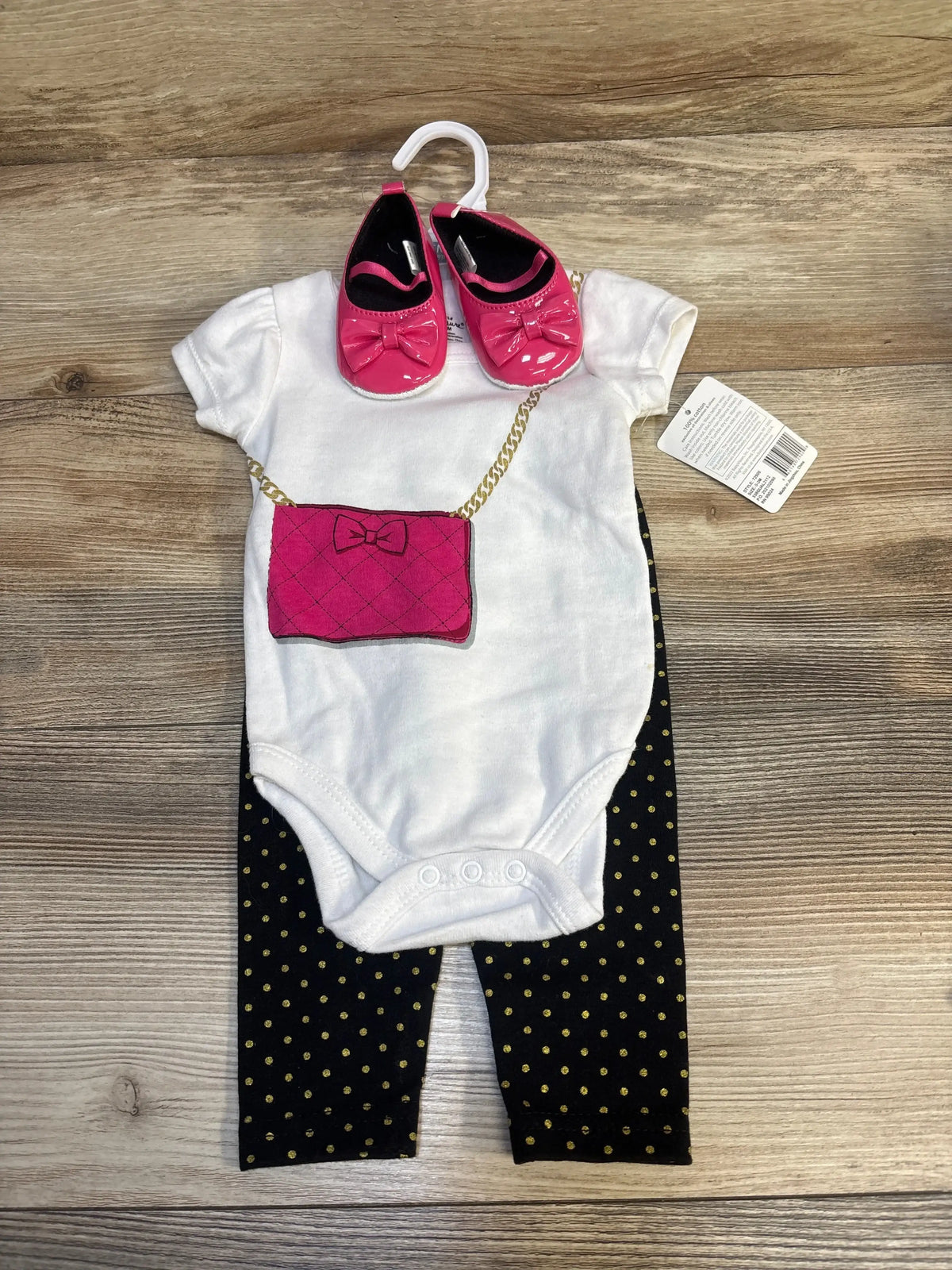 Baby girl outfit set with white bodysuit, black polka dot leggings, and pink bow shoes