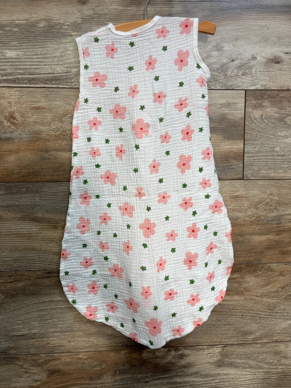 Front view of BSTOPPT gauze sleep sack showcasing pink and green floral print on white gauze with a wooden hanger