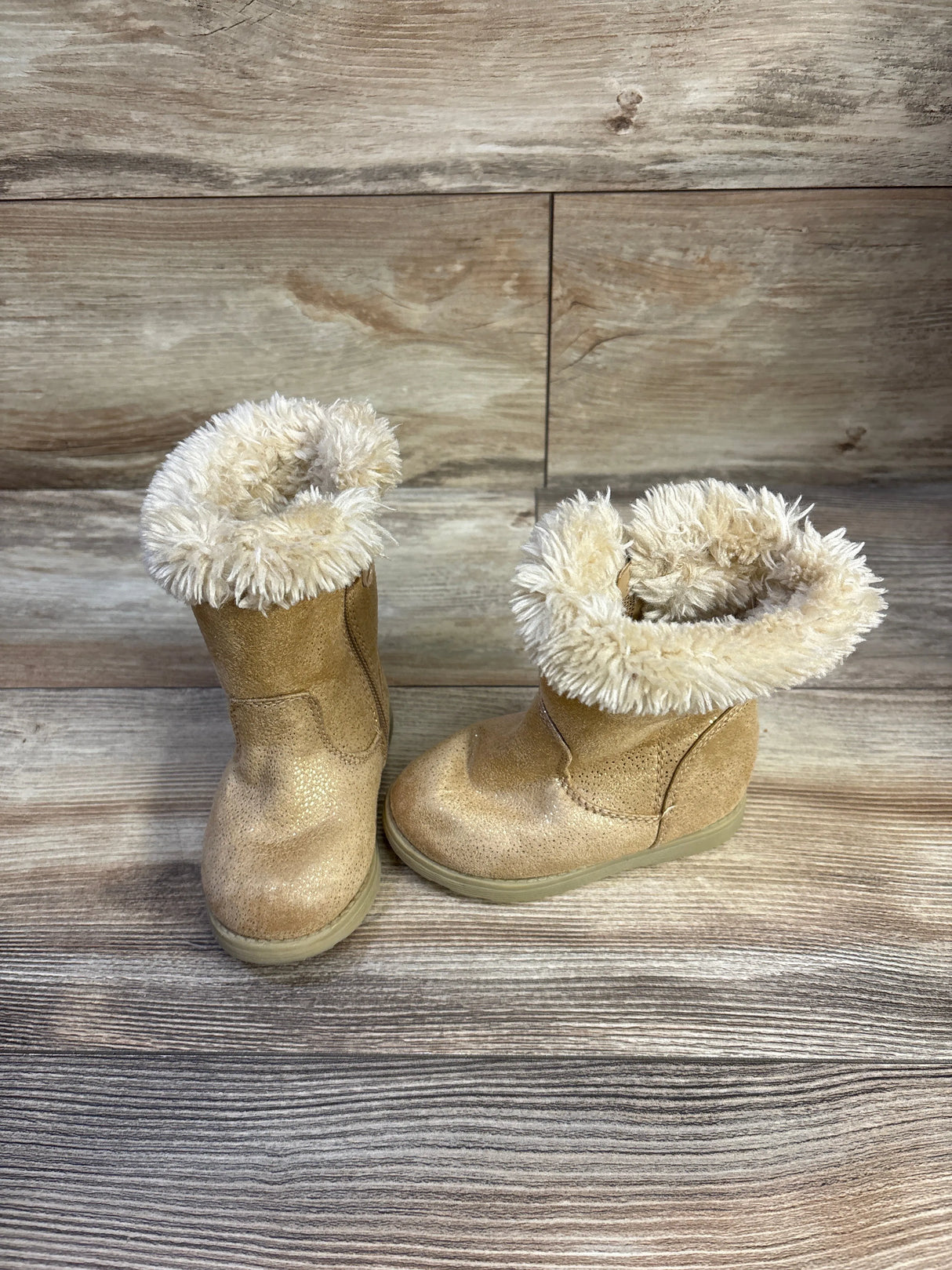 Front three-quarter view of Cat & Jack Leah toddler winter boots size 6C showing faux-fur cuff and textured cognac upper on wood background