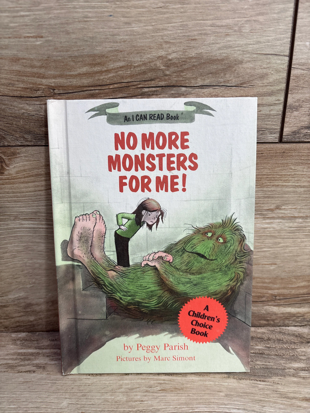 Children's book cover of No More Monsters For Me! by Peggy Parish with illustration of girl and green monster