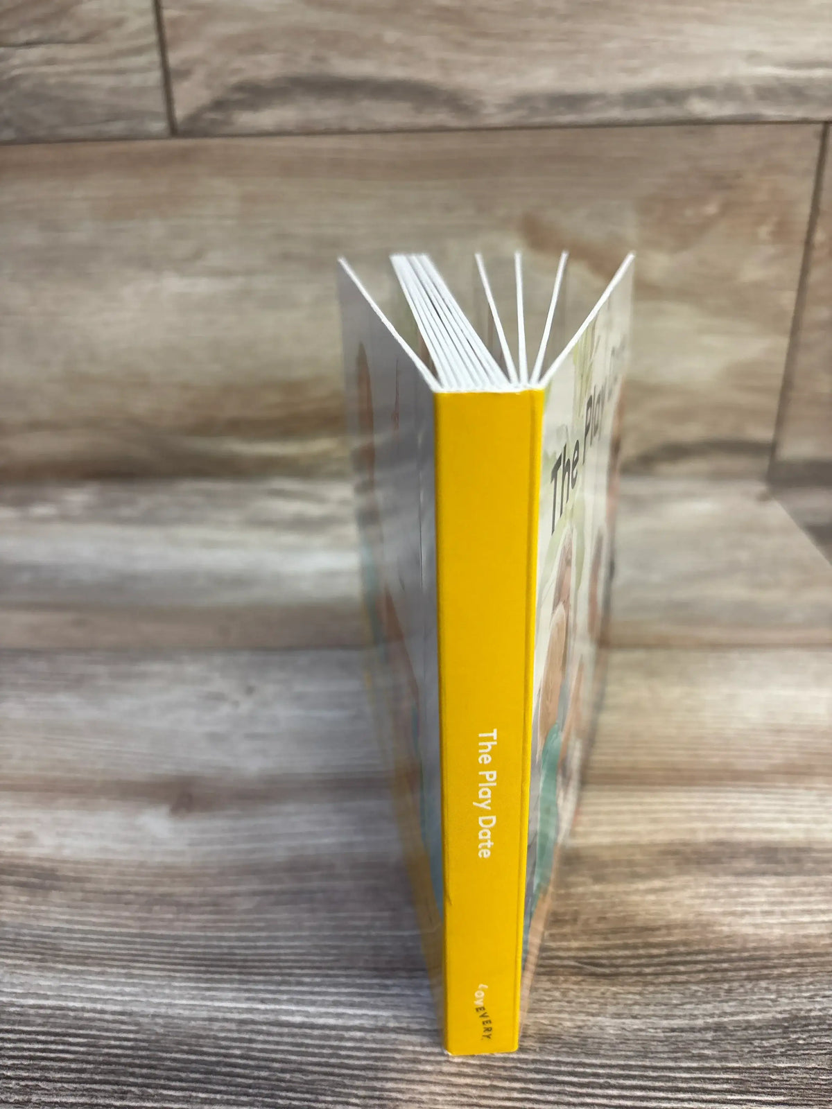 The Play Date children's book with yellow spine, ideal for kids' storytime and early learning.