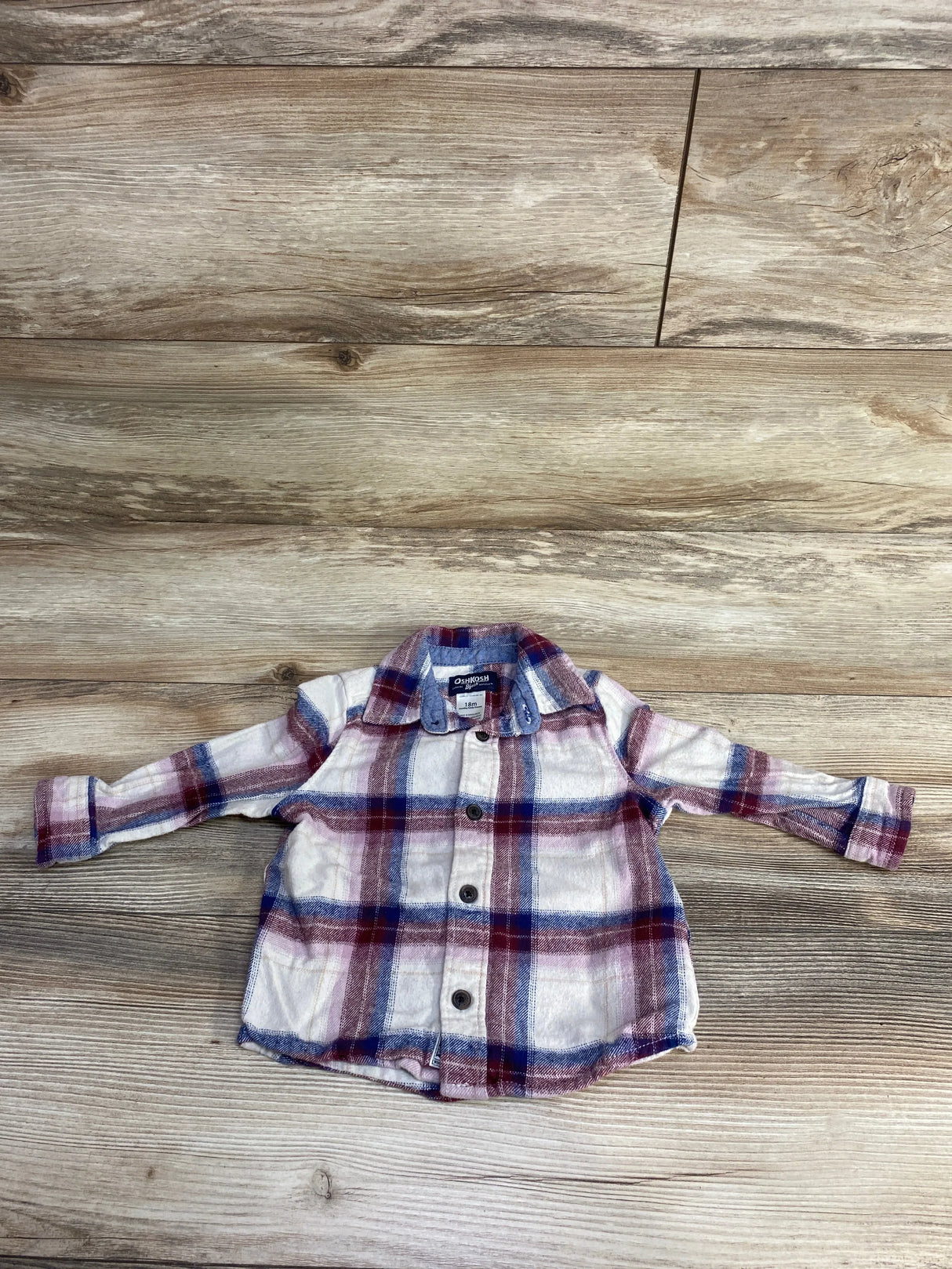 OshKosh B'gosh baby plaid button-up shirt in white, red, and blue, size 18 months on wood floor