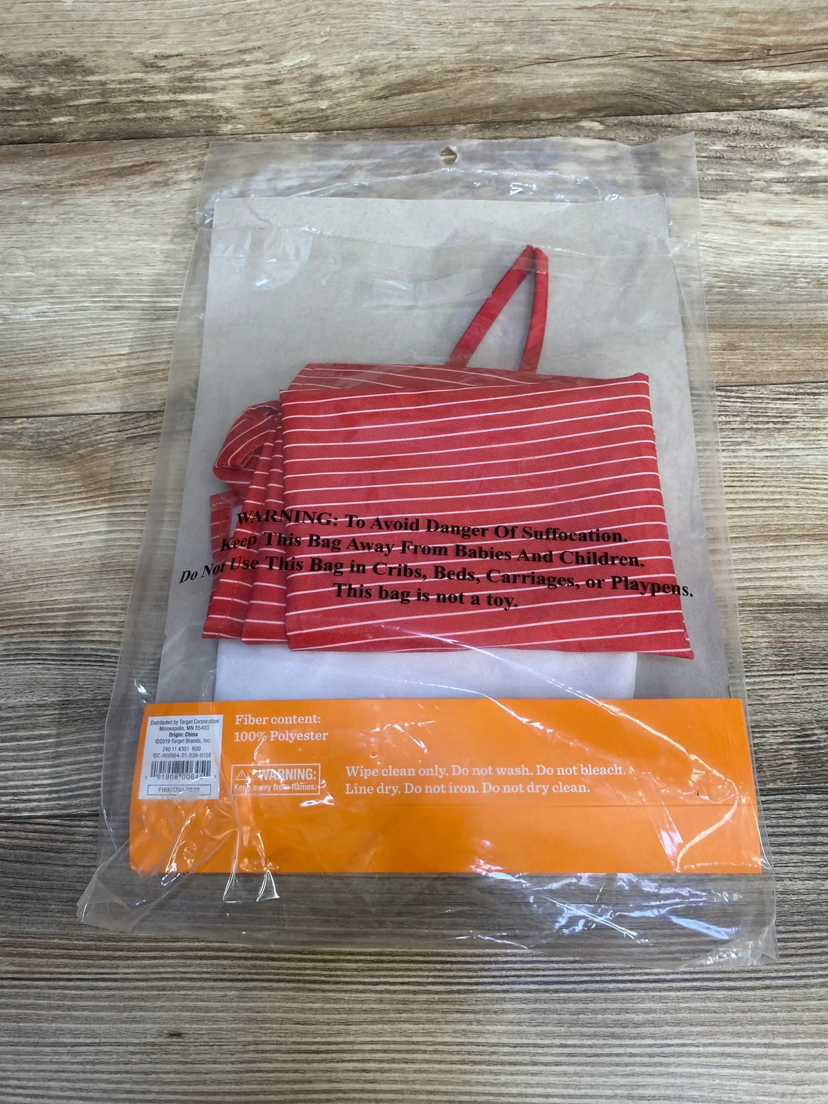 Front view of Hyde and Eek! Deli Worker Costume, size 3T, showcasing red-and-white striped apron in clear packaging