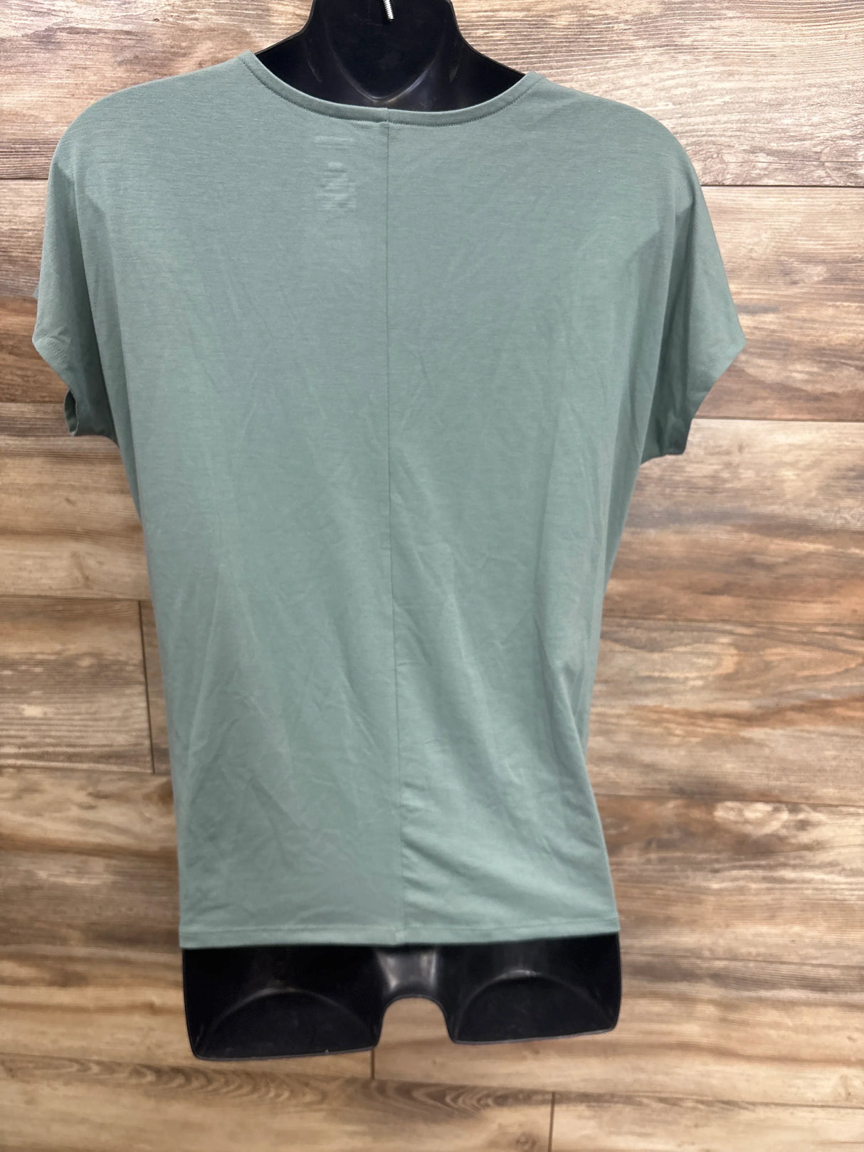 Sage green maternity t-shirt on mannequin, soft cotton blend, short sleeves, round neckline, perfect for pregnancy comfort