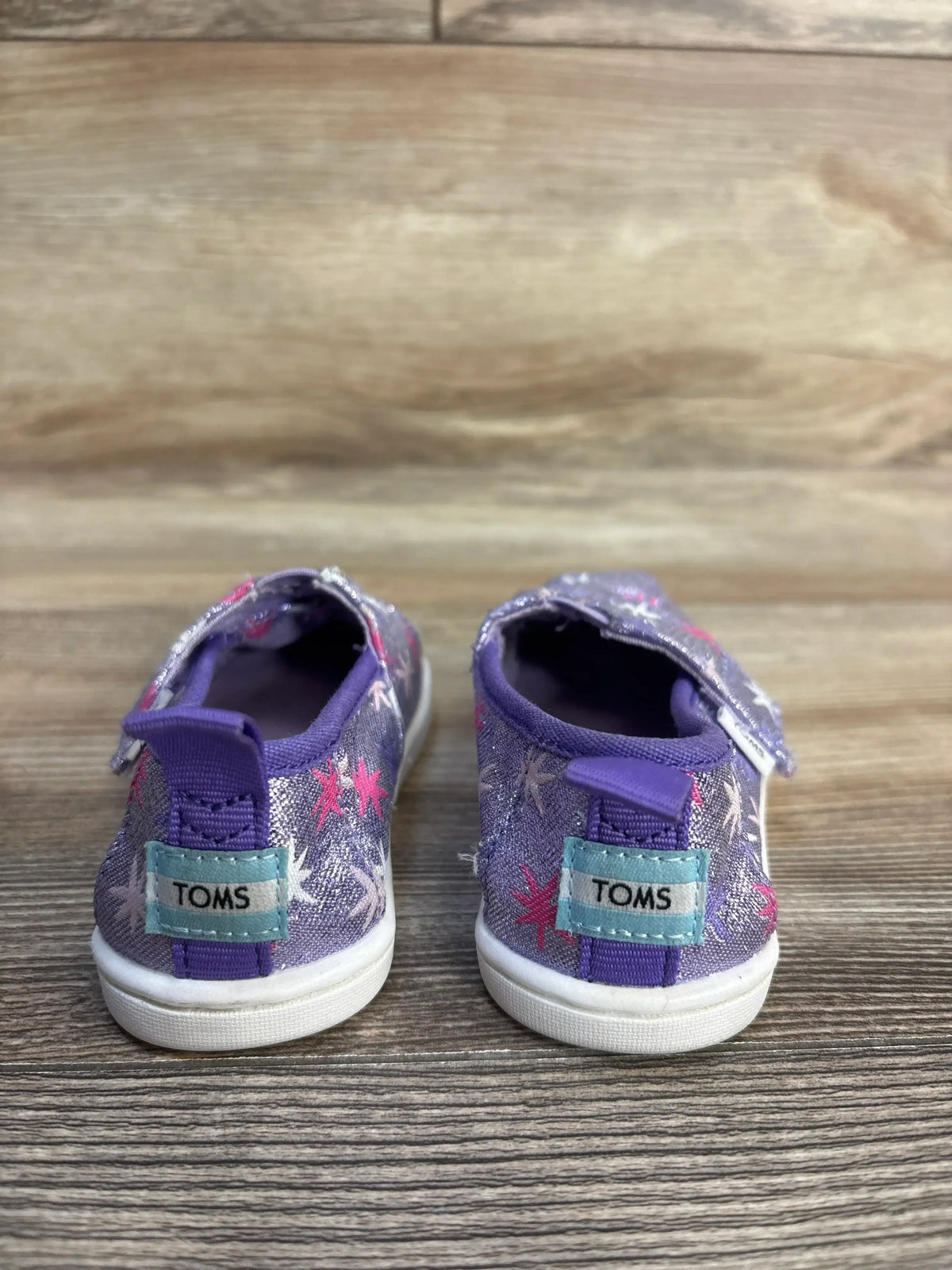 Purple Toms toddler shoes with pink stars and glitter, perfect for kids' casual wear