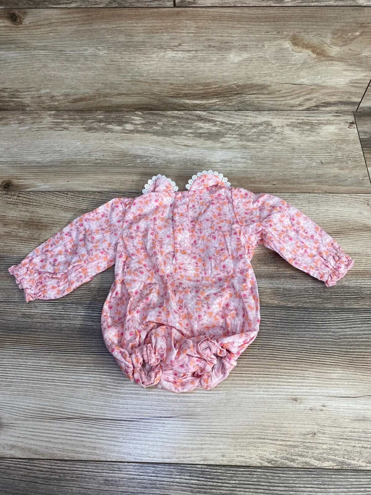 Front view of pink Cat & Jack long-sleeve floral romper (size 3-6 months) showcasing all-over floral print and snap crotch on white background