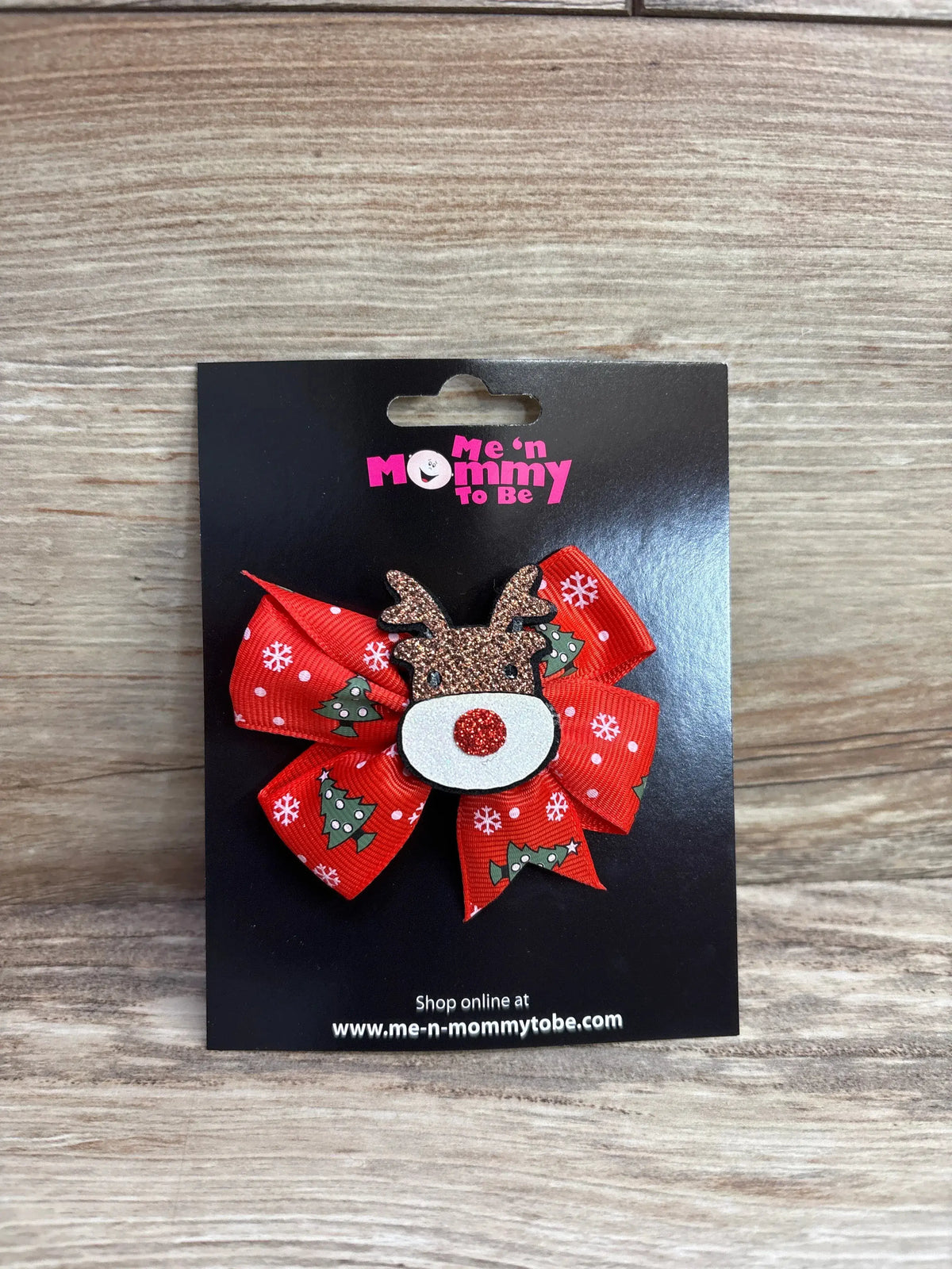 Red Christmas bow with reindeer face, snowflakes, and trees for kids' holiday outfits