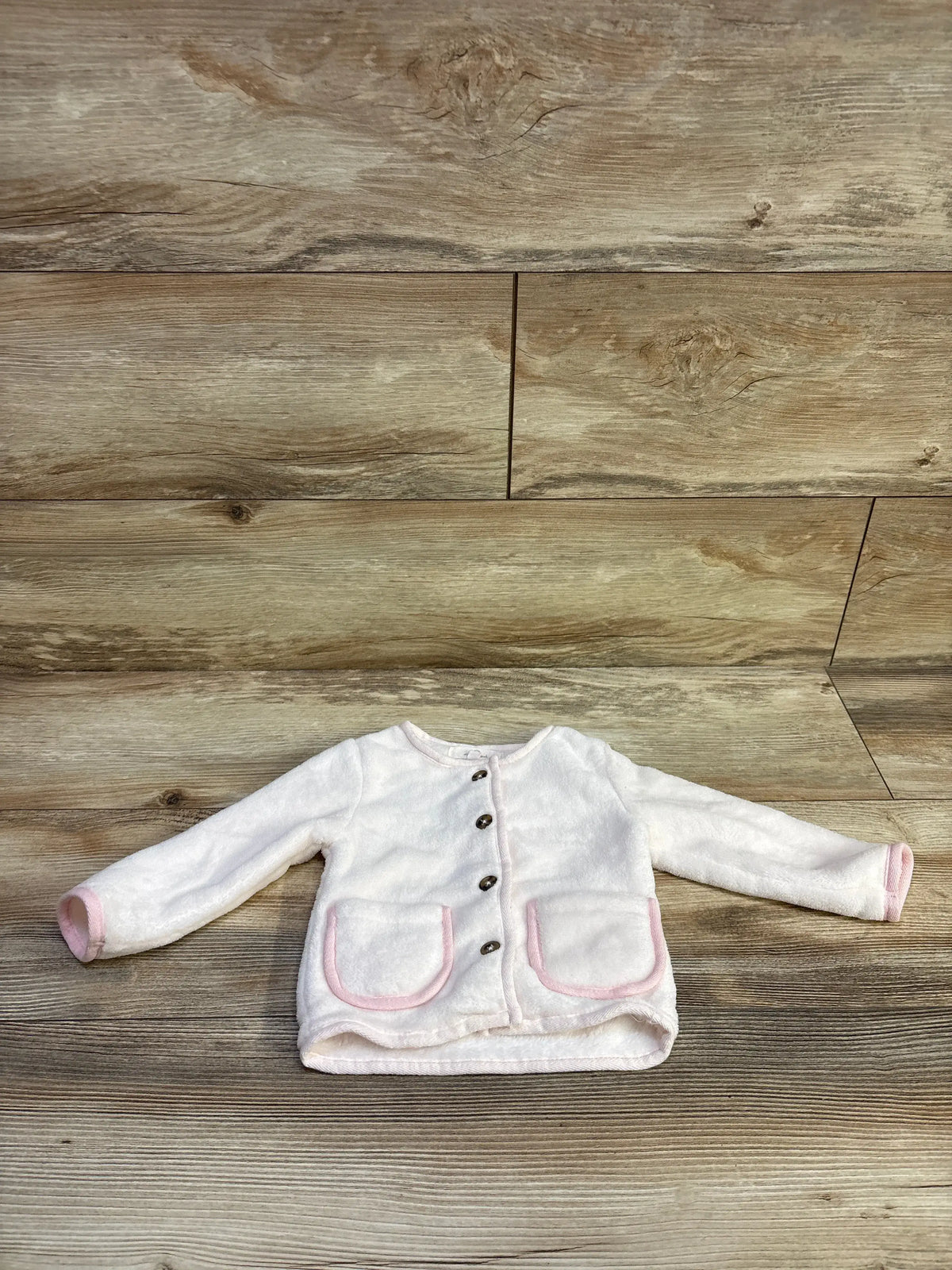 Starting Out plush white button-up cardigan for baby with pink trim pockets