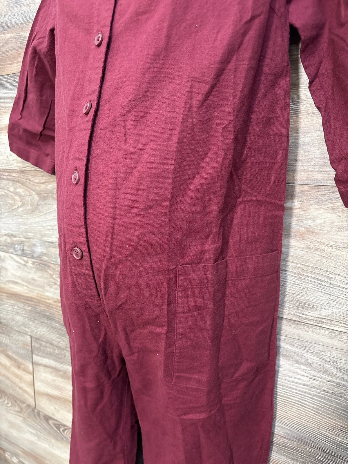 Close-up of a wine red button-front maternity jumpsuit by Me n Mommy To Be.