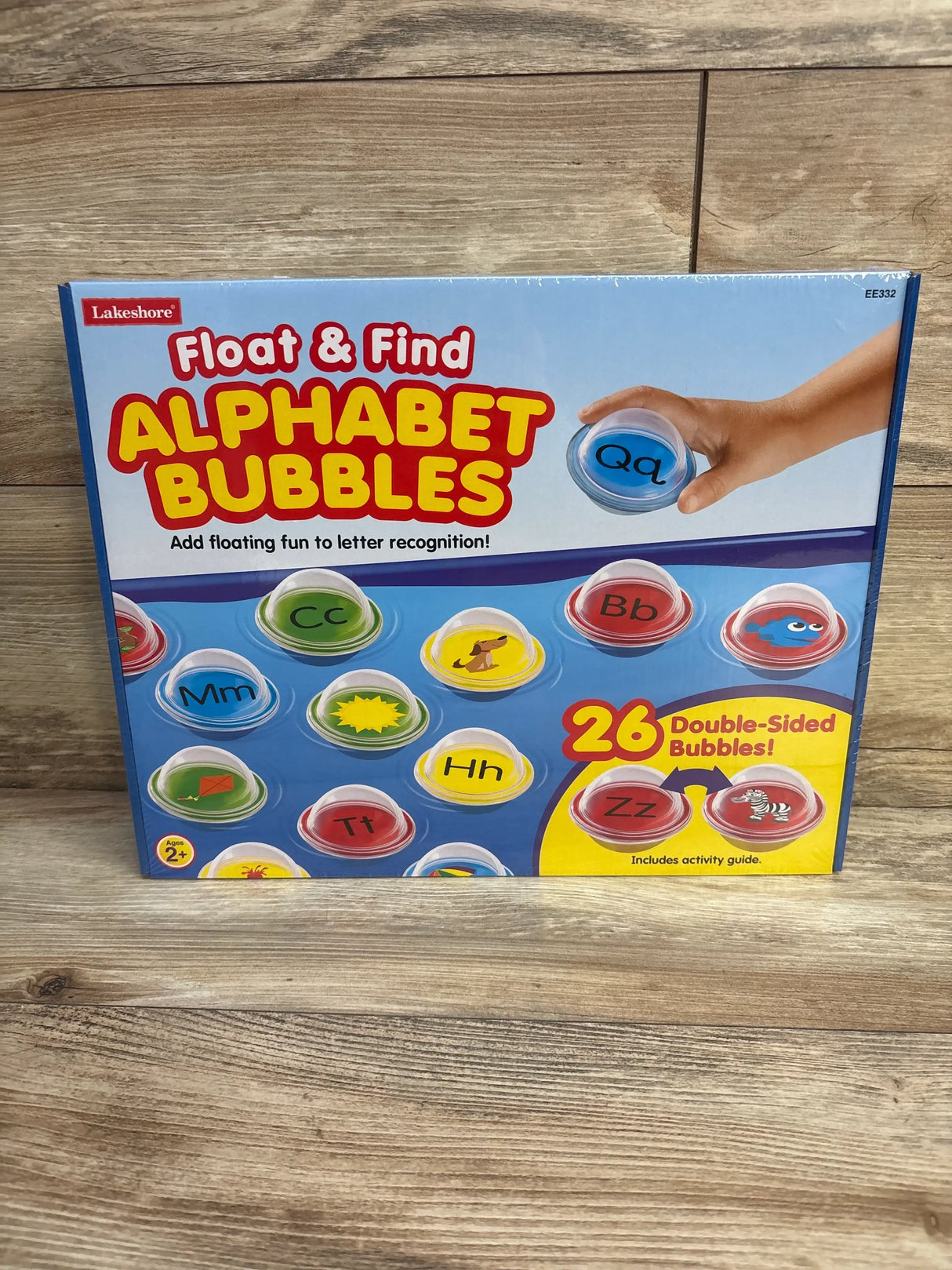 Front view of Lakeshore Float & Find Alphabet Bubbles box showing colorful double-sided letter bubbles on a wood floor